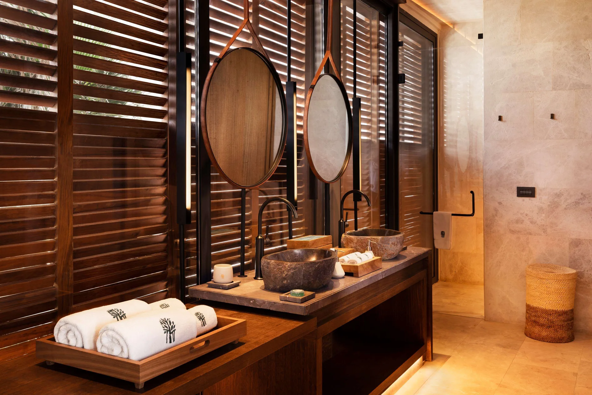 Oceanfront Balcony Pool Suite bathroom with twin stone basins at Banyan Tree Mayakoba.