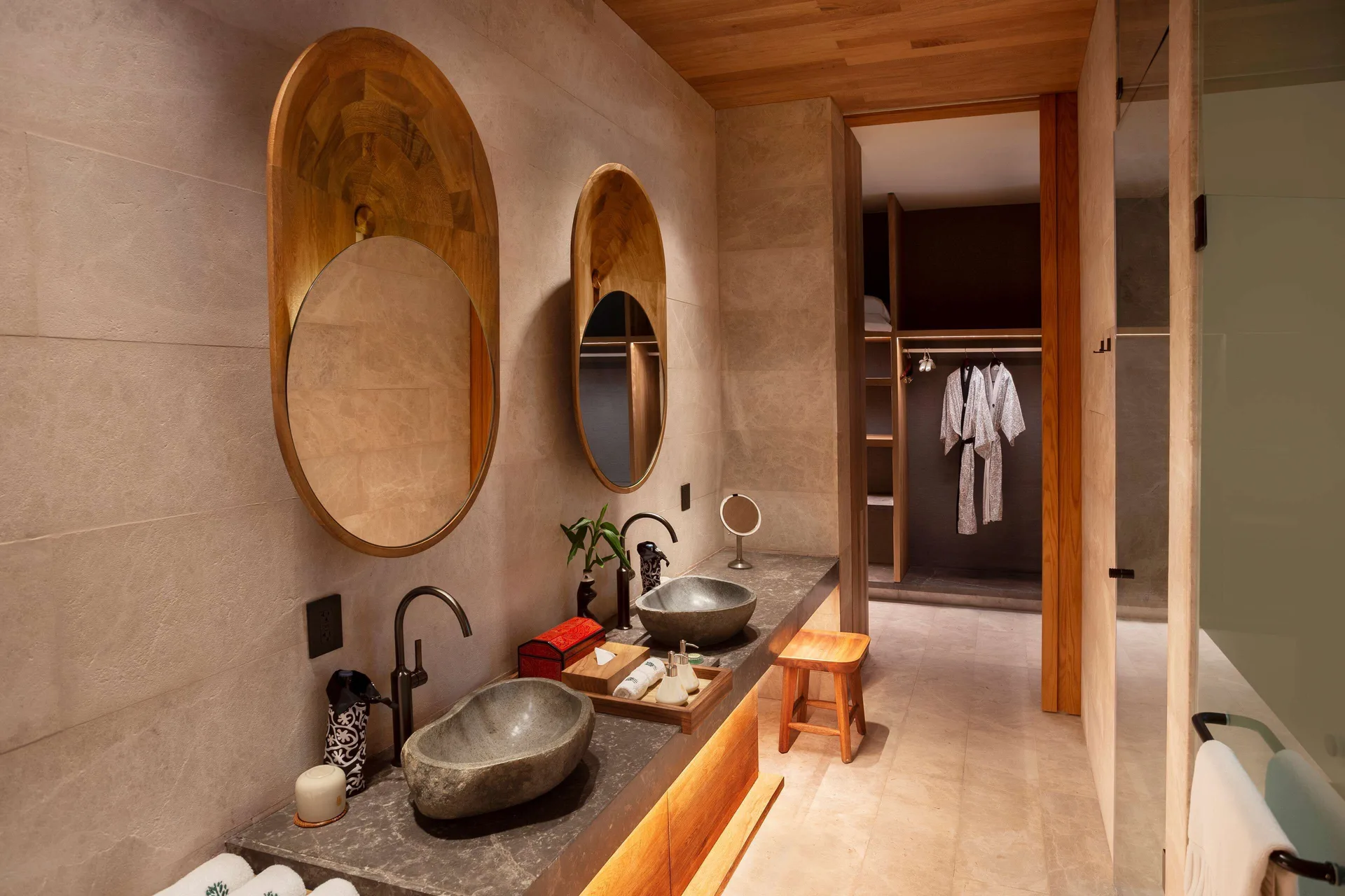 Oceanfront Veranda Pool Suite bathroom with twin stone sinks at Banyan Tree Mayakoba