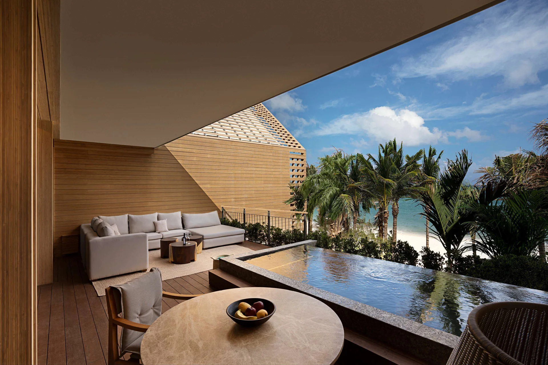 Oceanfront Veranda Pool Suite veranda with pool, sofa, palms and sea at Banyan Tree Mayakoba.