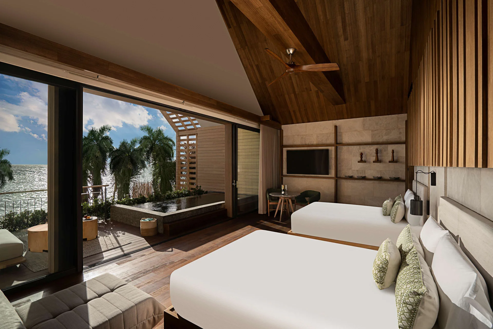 Oceanfront Veranda Pool Suite two-bed room opening to pool and sea at Banyan Tree Mayakoba.