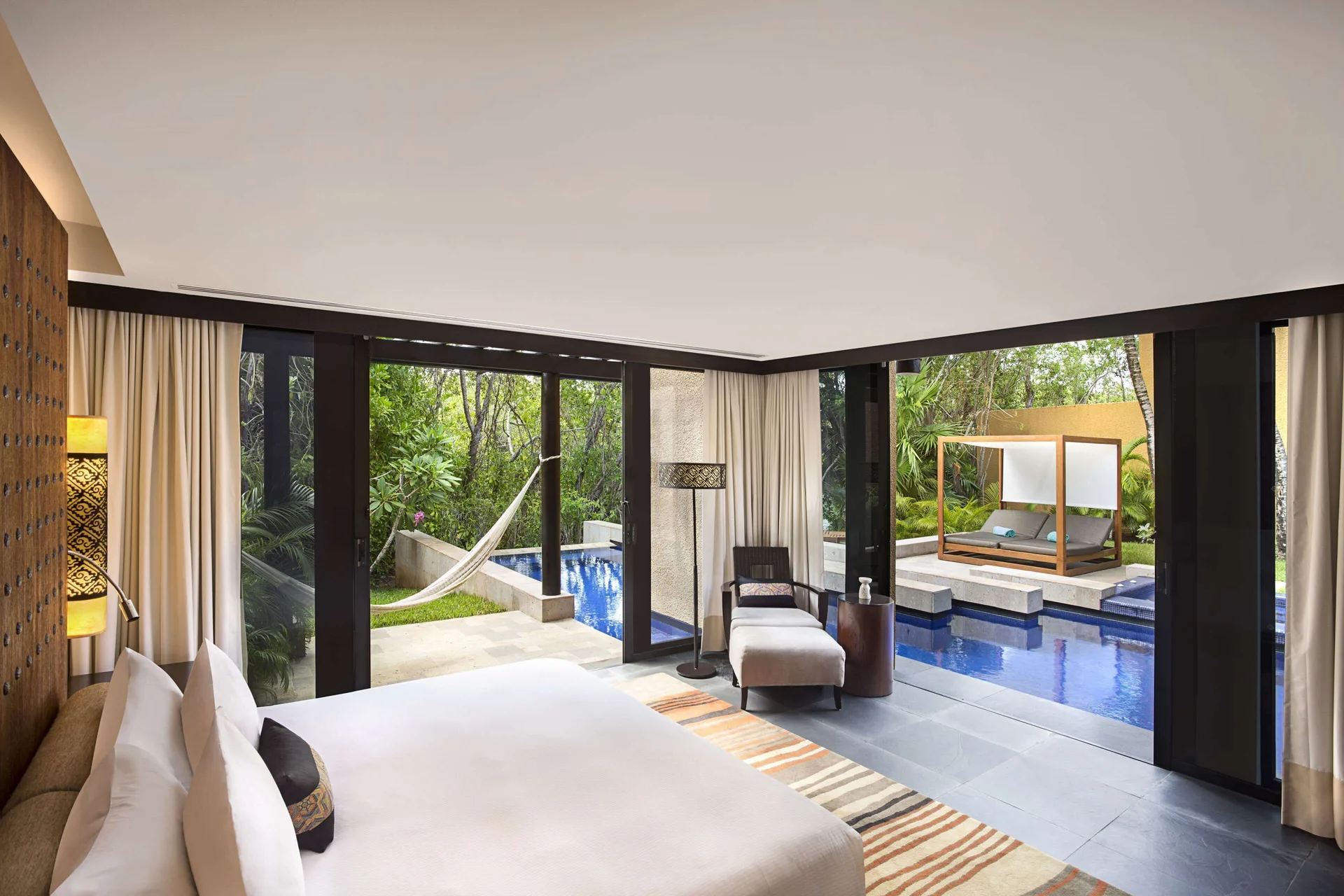 King bedroom of a Serenity Two Bedroom Pool Villa at Banyan Tree Mayakoba opening to a private pool.