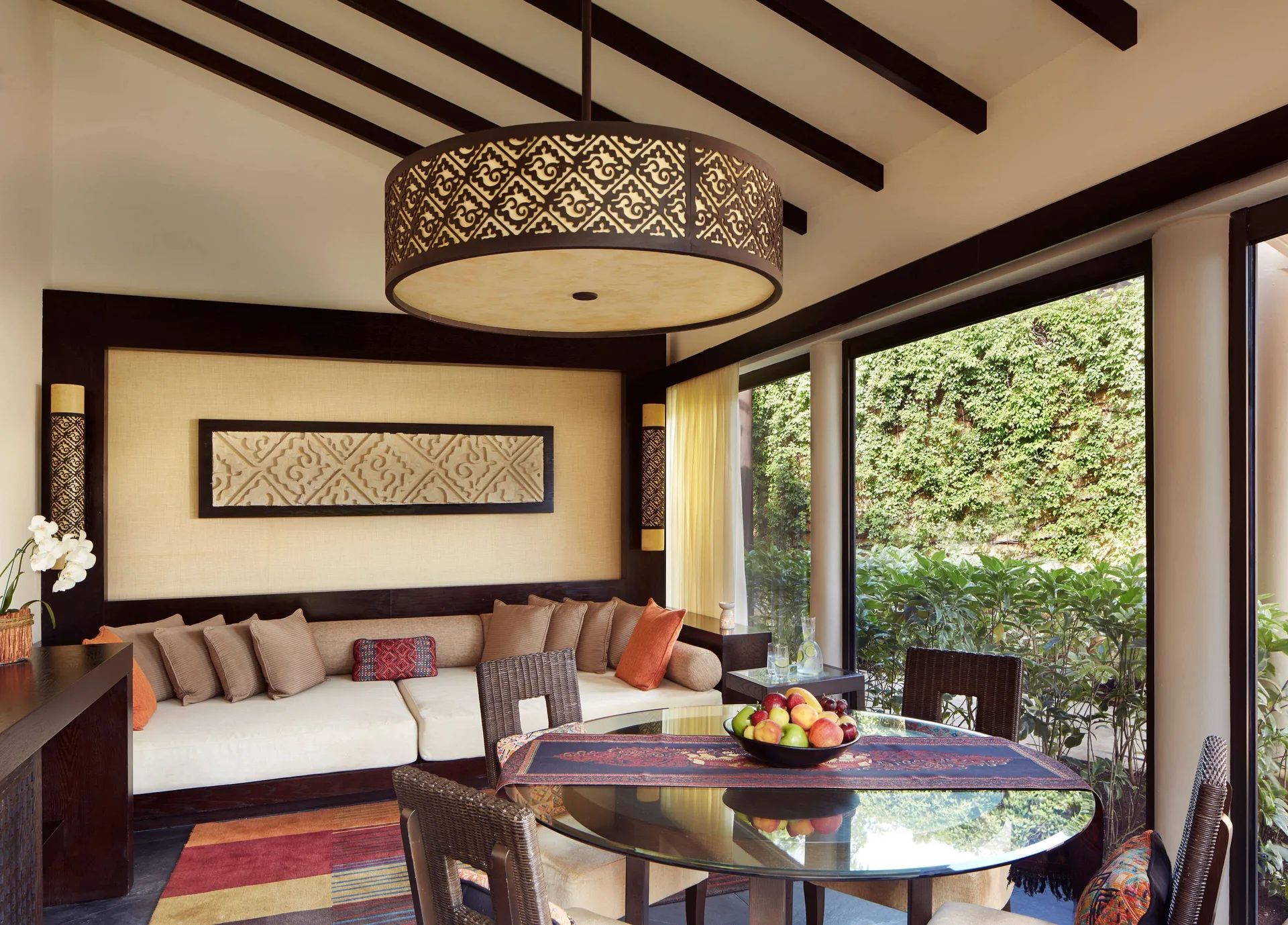 Living and dining area of a Serenity Two Bedroom Pool Villa at Banyan Tree Mayakoba with garden views.