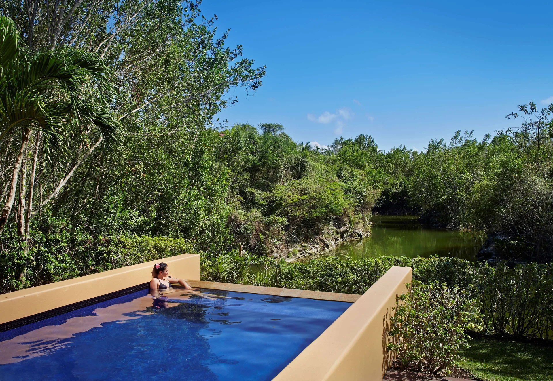 Private pool of a Serenity Two Bedroom Pool Villa at Banyan Tree Mayakoba overlooking a lagoon.