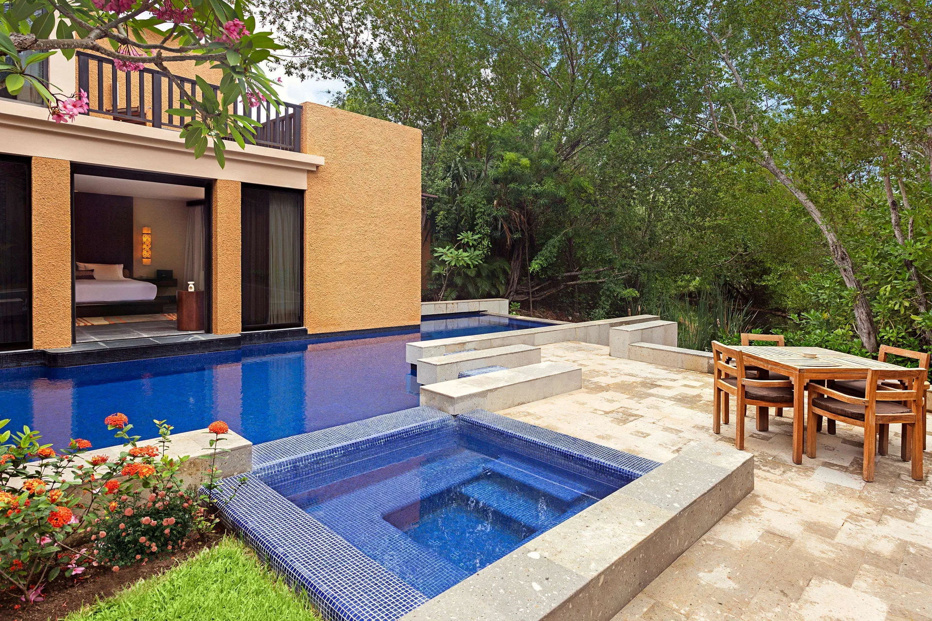 Private pool terrace of a Serenity Two Bedroom Pool Villa at Banyan Tree Mayakoba with outdoor dining.