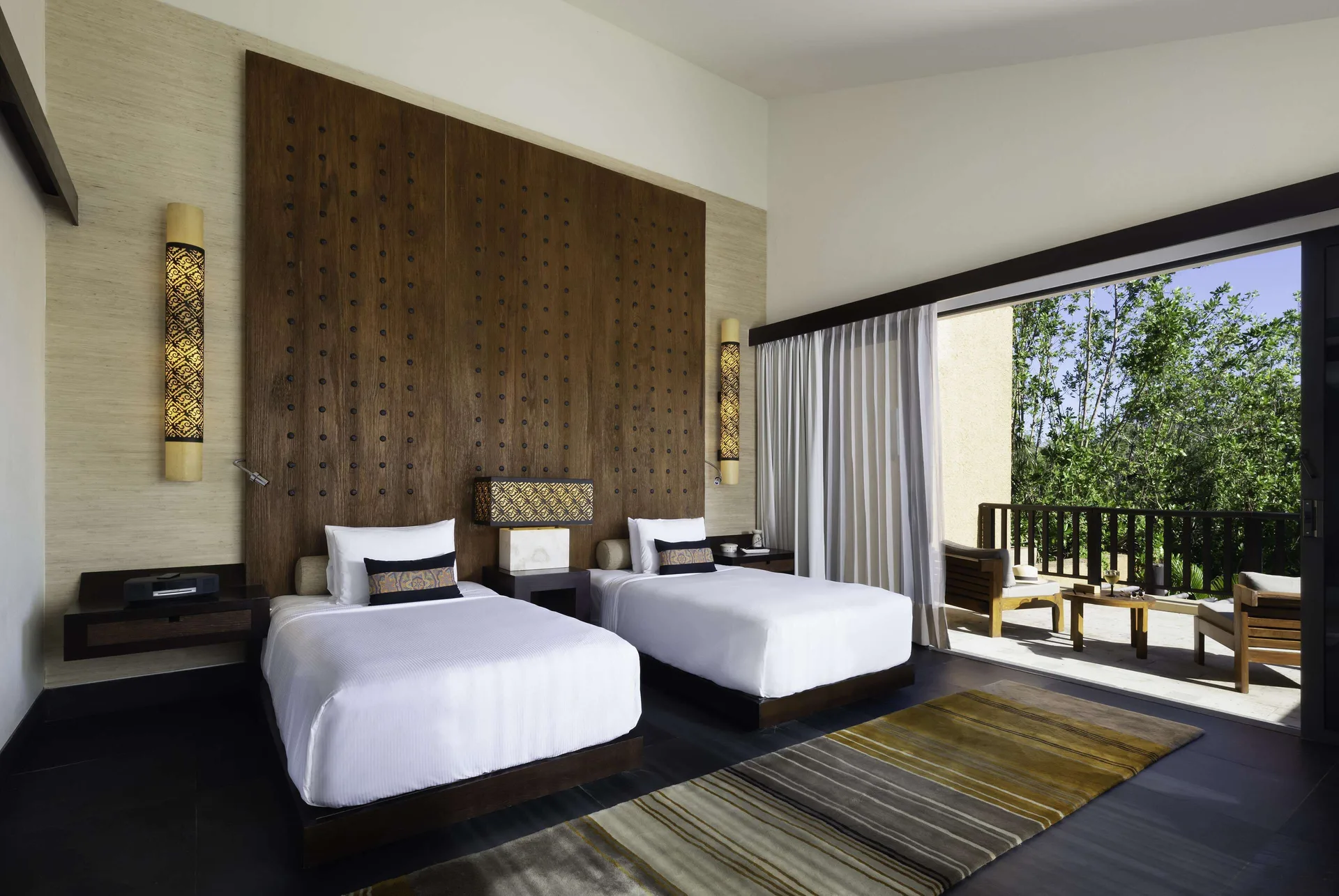 Twin bedroom in a Serenity Two Bedroom Pool Villa at Banyan Tree Mayakoba with a furnished balcony.