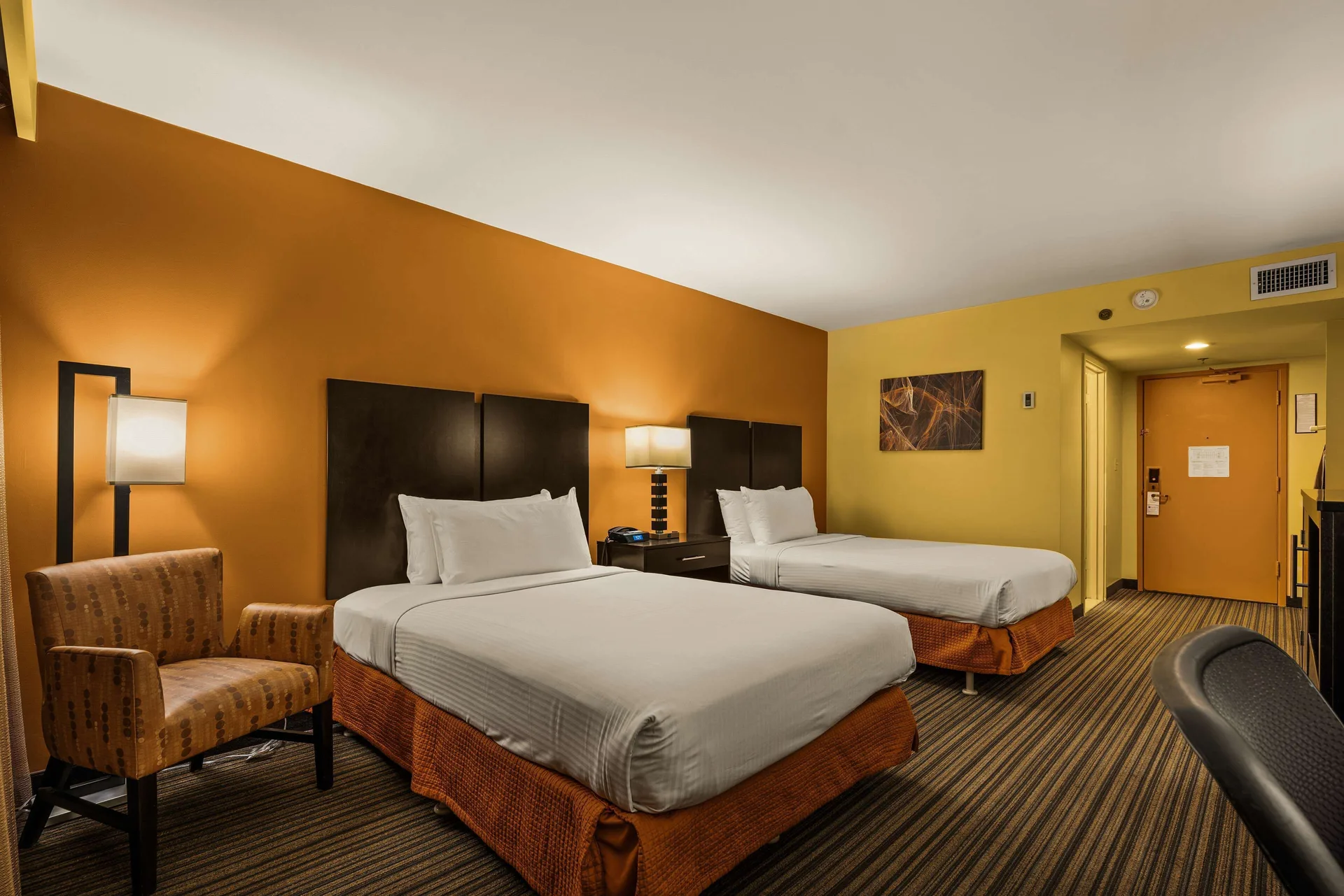 Standard room with two beds and armchair at Best Western The Plaza Hotel Honolulu Airport.