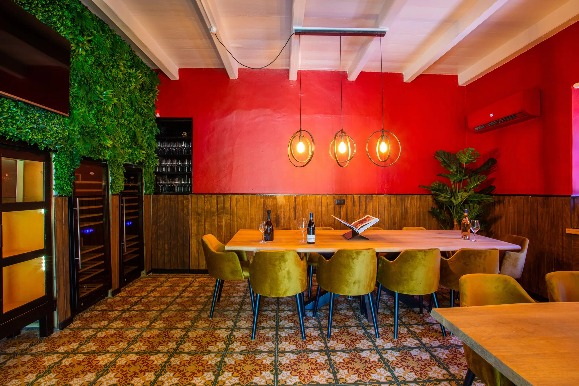 Red-walled dining room with pendant lights at Blue Bay Curacao Golf & Beach Resort.