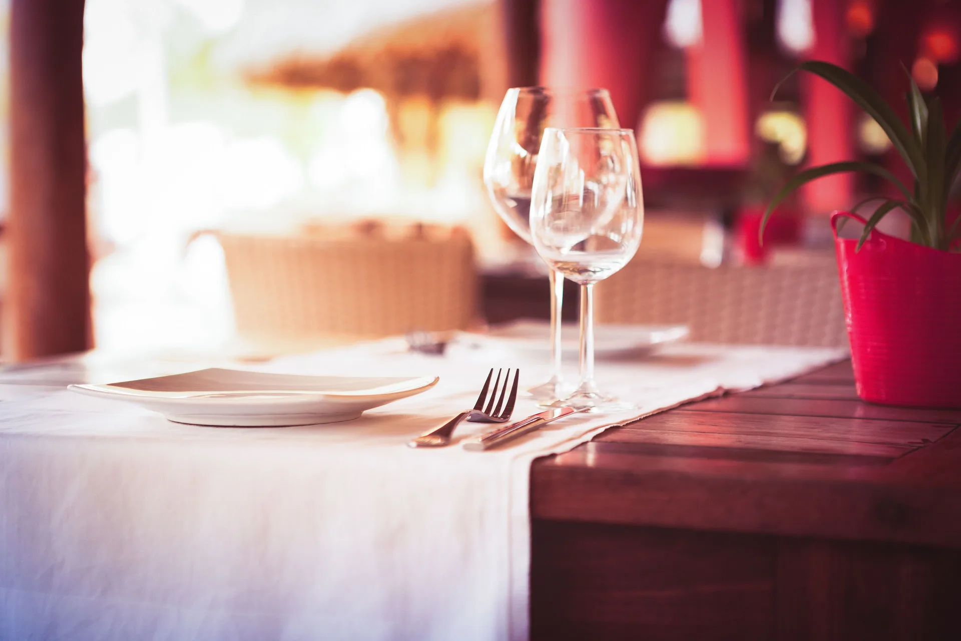 Close-up of a table setting with wine glasses at Blue Bay Curacao Golf & Beach Resort.