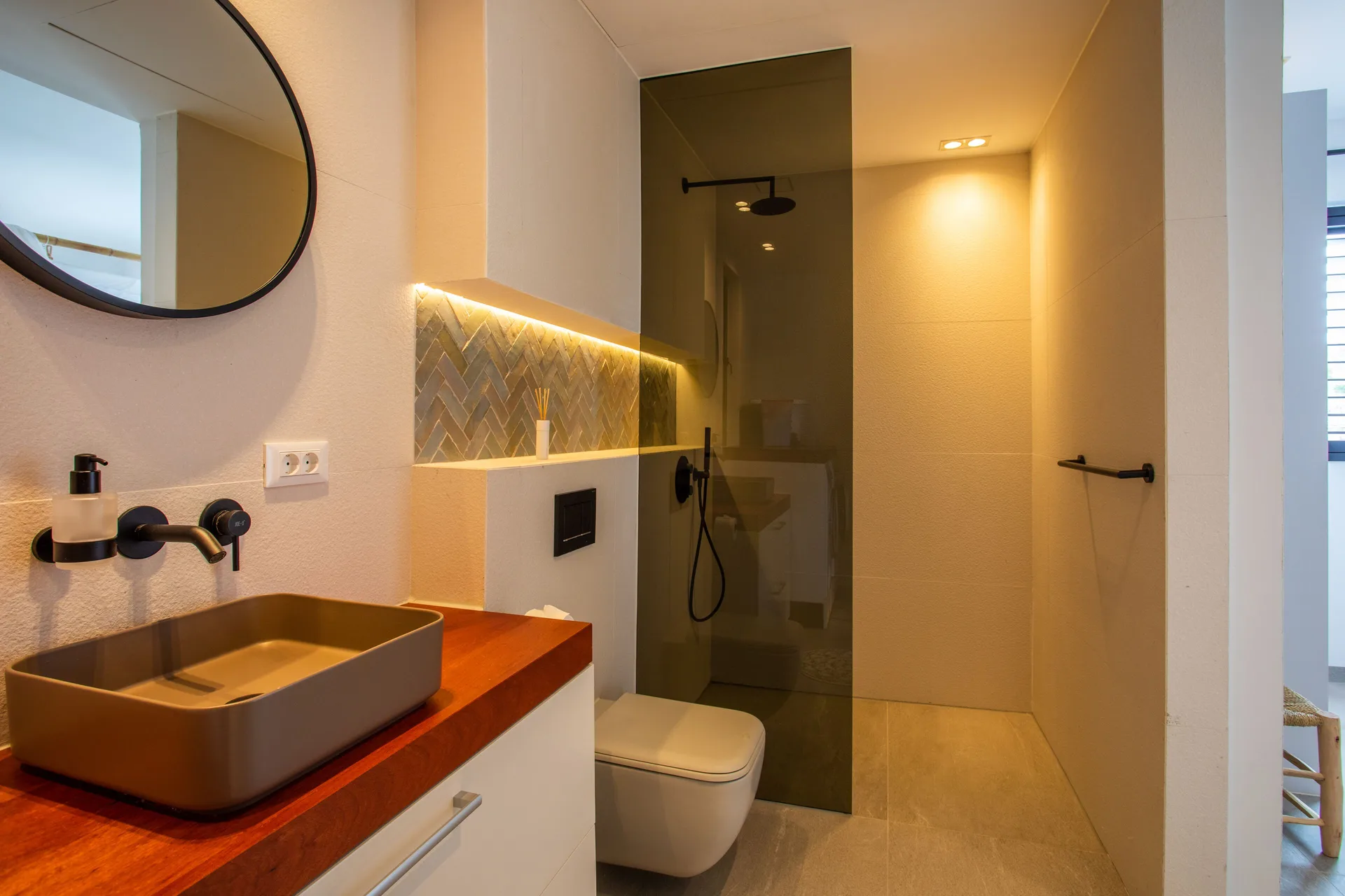 Penthouse bathroom with vessel sink and walk-in shower at Blue Bay Curacao Golf & Beach Resort.
