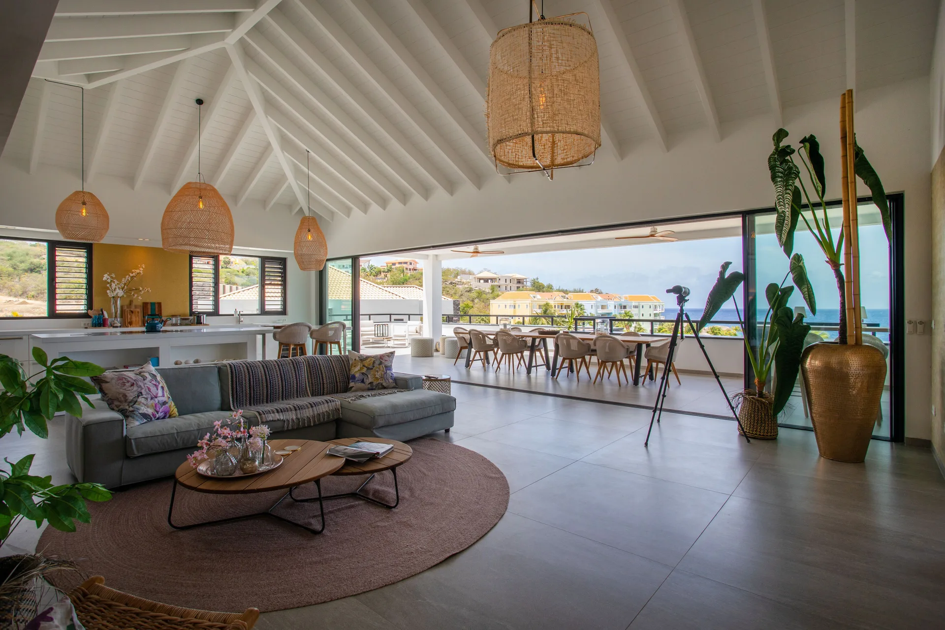 Penthouse living room with terrace dining and ocean view at Blue Bay Curacao Golf & Beach Resort.