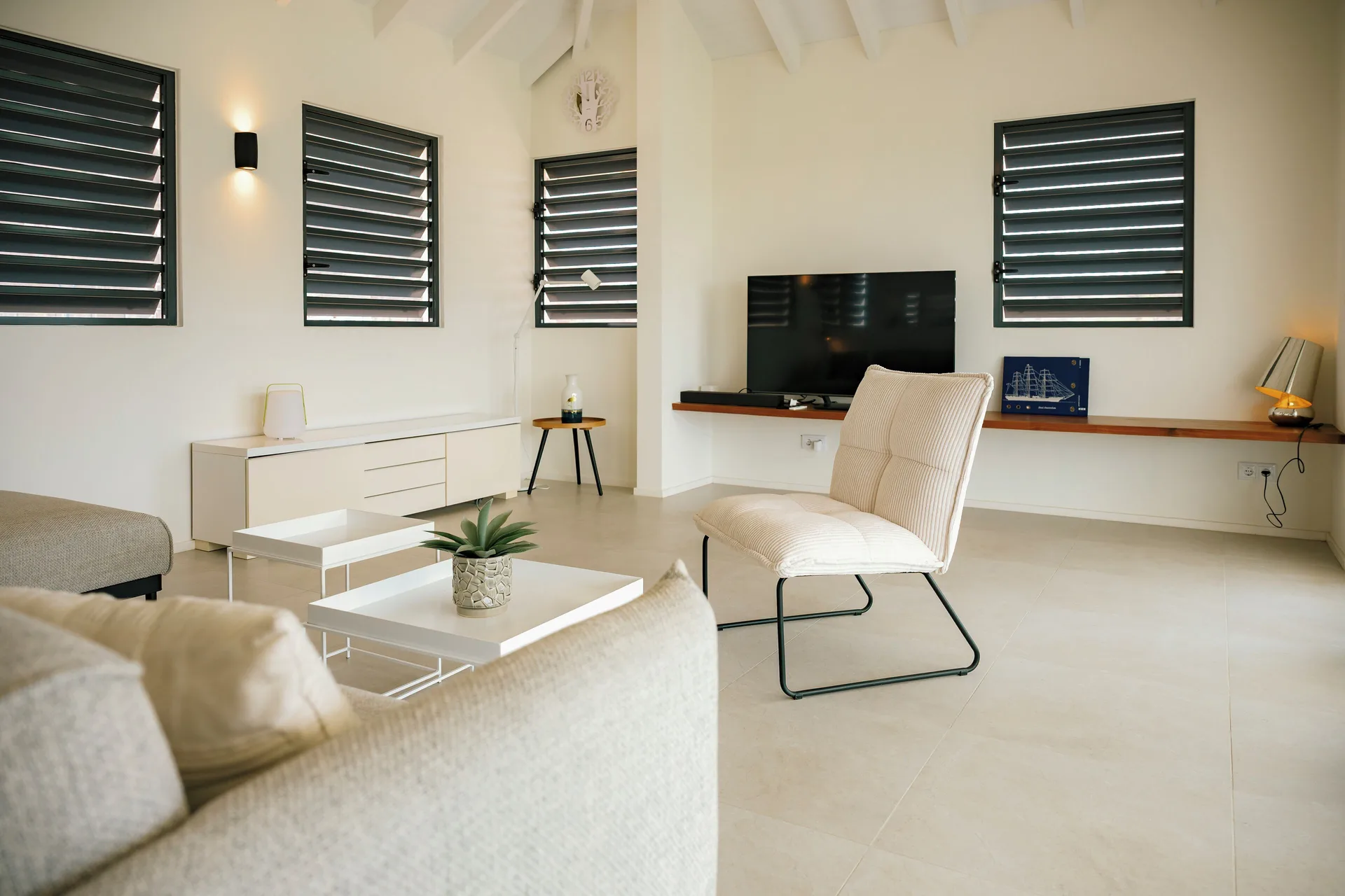 Deluxe Villa living room with TV wall at Blue Bay Curacao Golf & Beach Resort.
