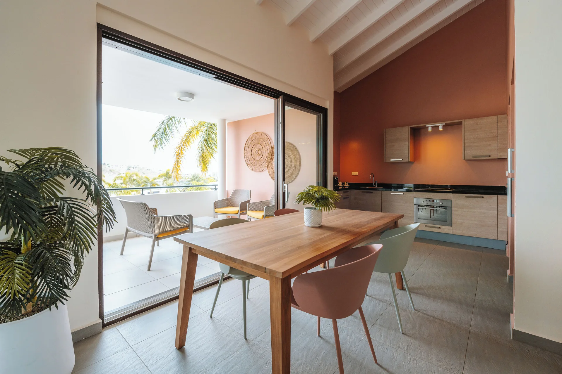 Garden Apartment 2 Bedroom dining table, kitchen, and balcony at Blue Bay Curacao Golf & Beach Resort.