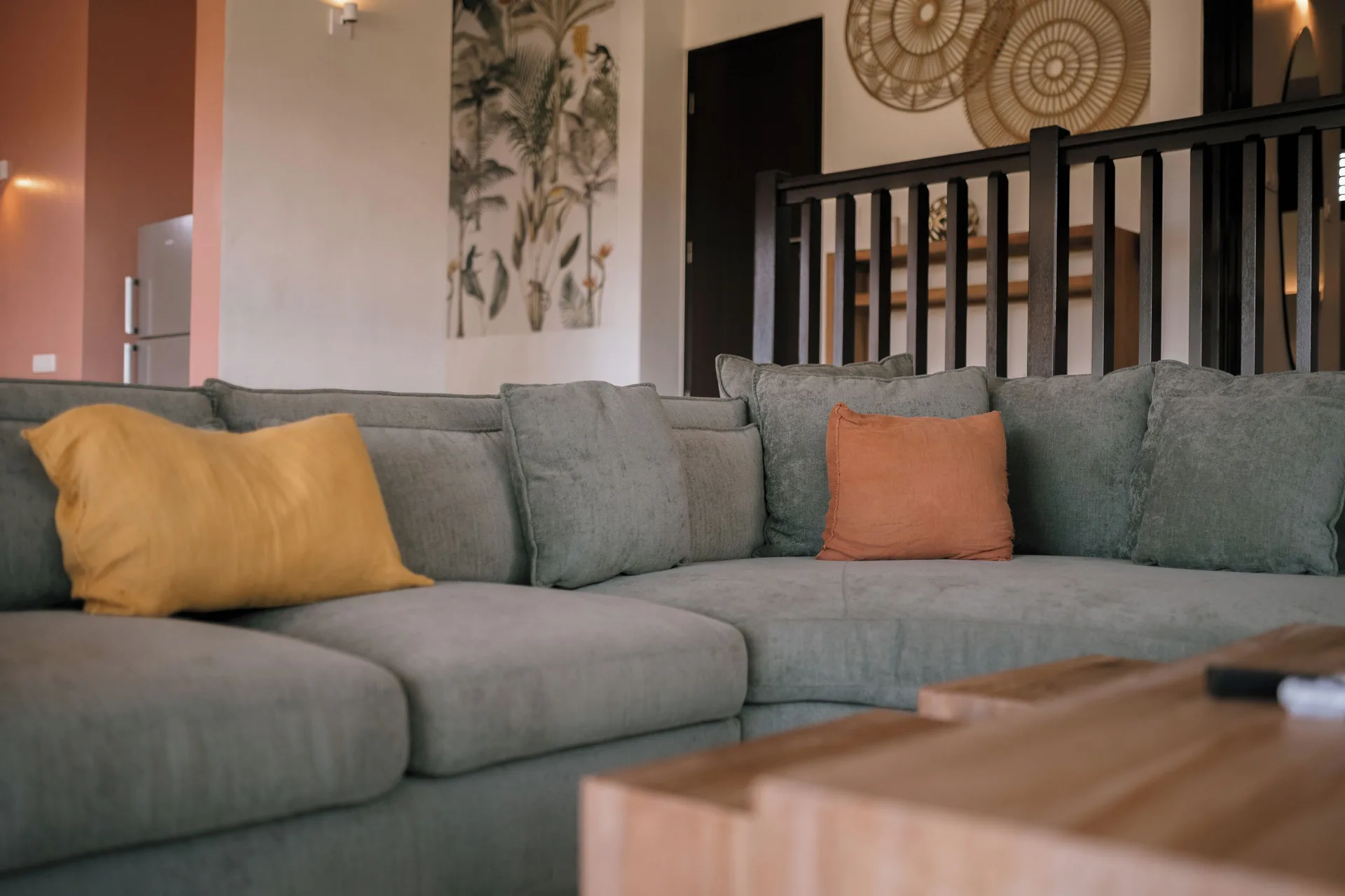 Garden Villa 2 Bedroom living area at Blue Bay Curacao Golf & Beach Resort with sectional sofa and pillows.