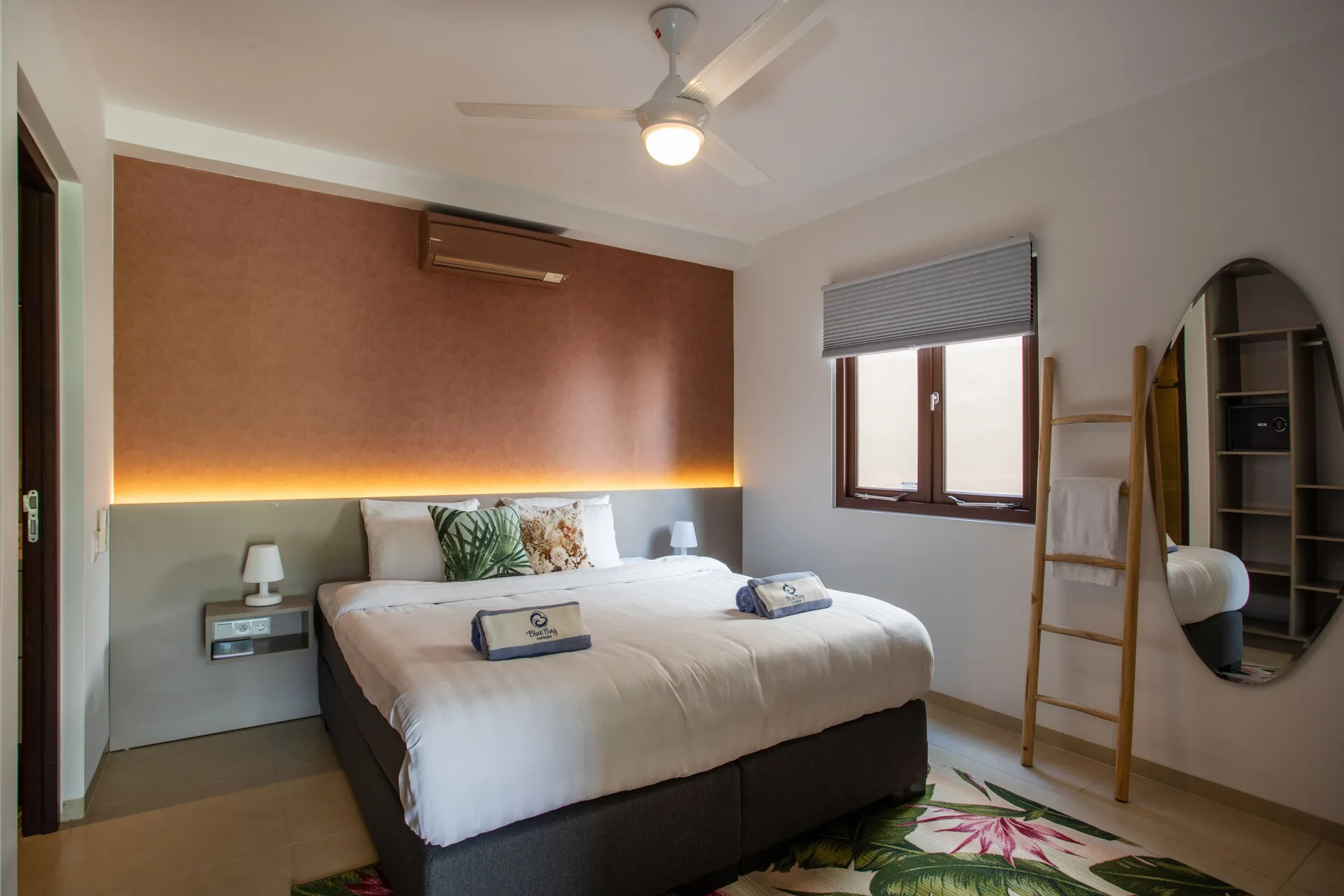 King bedroom in a Greenview apartment at Blue Bay Curacao Golf & Beach Resort with warm accent lighting.