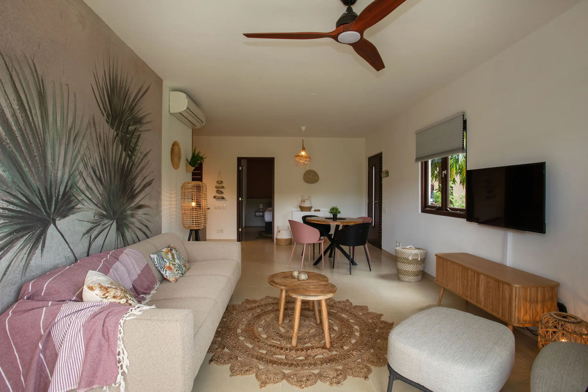 Greenview 2-bedroom Apartment living room at Blue Bay Curacao Golf & Beach Resort with sofa and dining area.