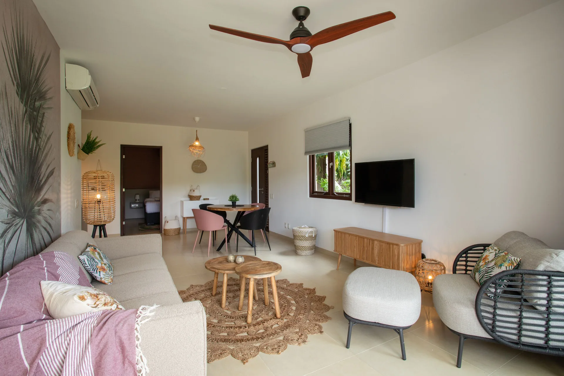 Greenview 2-bedroom Apartment lounge at Blue Bay Curacao Golf & Beach Resort with TV, sofa, and chairs.