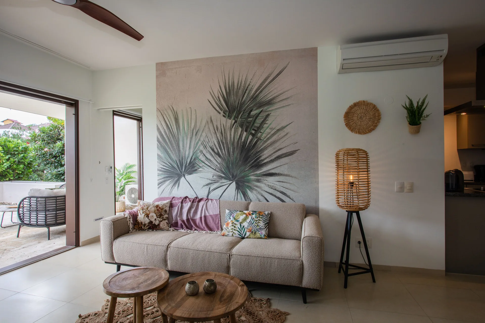 Greenview 2-bedroom Apartment sofa at Blue Bay Curacao Golf & Beach Resort beside open patio doors.