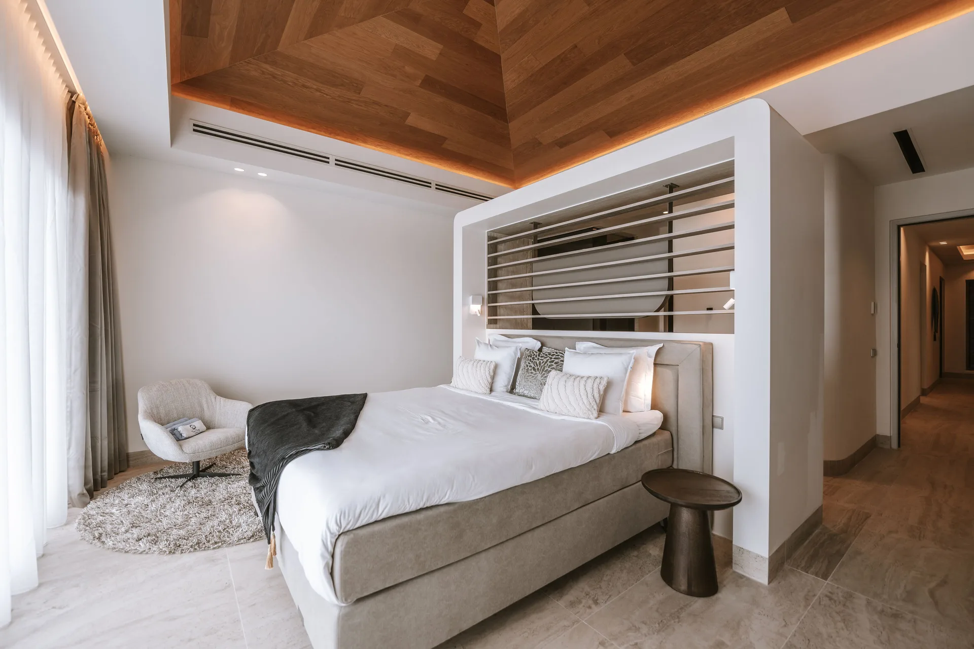 Luxury Penthouse Ocean View king bedroom with lounge chair at Blue Bay Curacao Golf & Beach Resort.