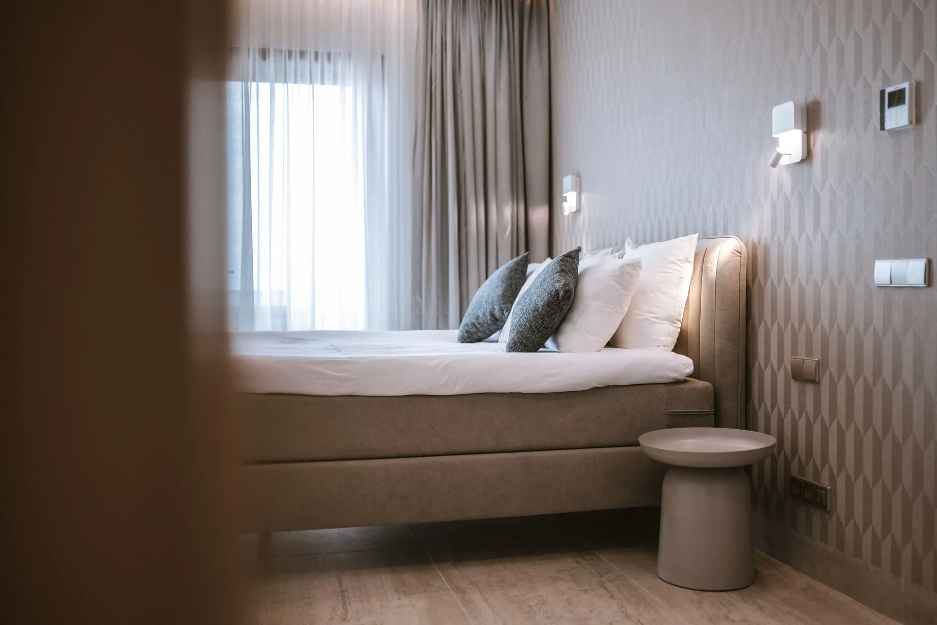 Luxury Penthouse Ocean View bed and side table at Blue Bay Curacao Golf & Beach Resort.