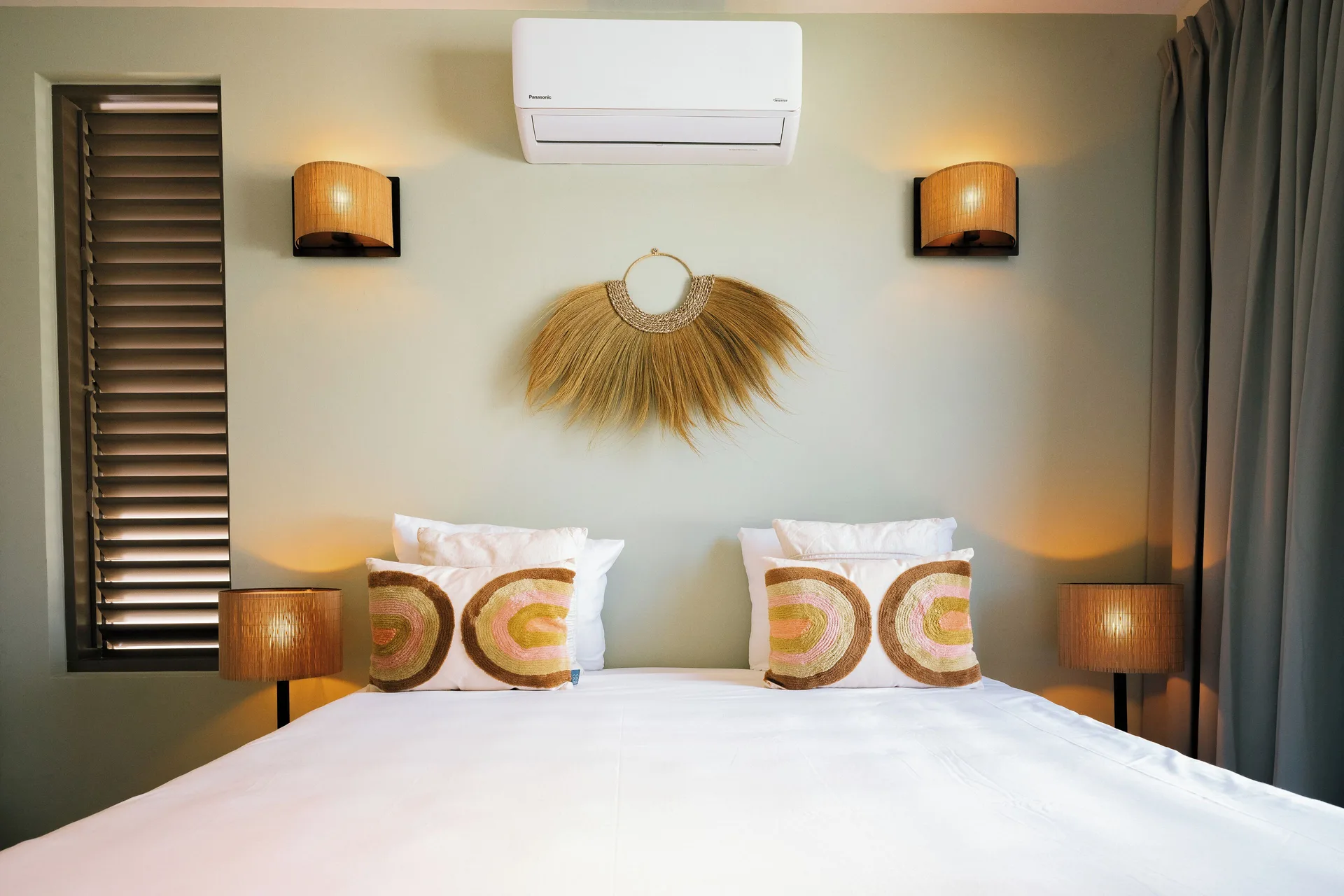 Private Pool Villa bedroom with large bed and woven wall decor at Blue Bay Curacao Golf & Beach Resort.