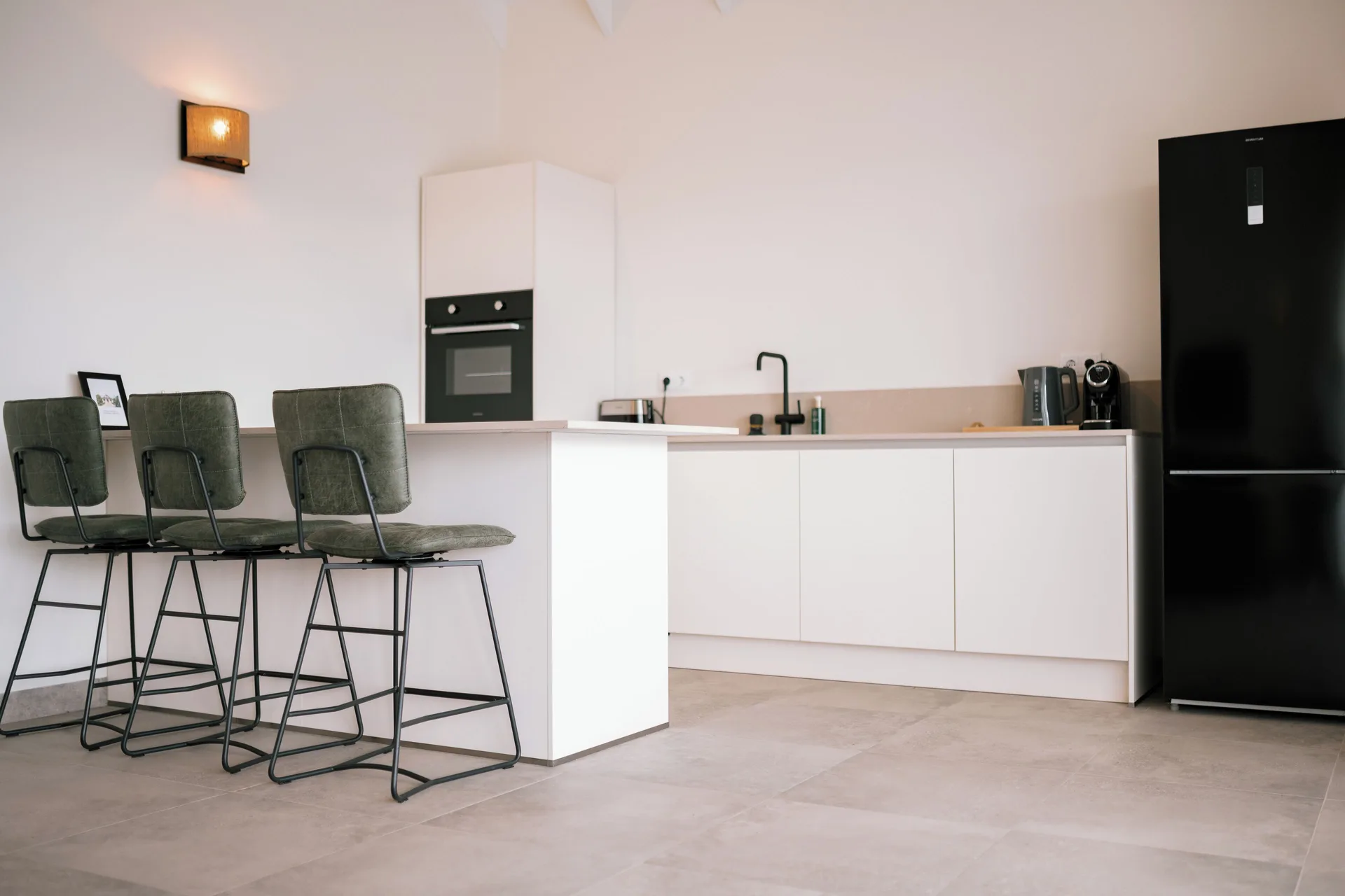 Private Pool Villa kitchen with breakfast bar and refrigerator at Blue Bay Curacao Golf & Beach Resort.