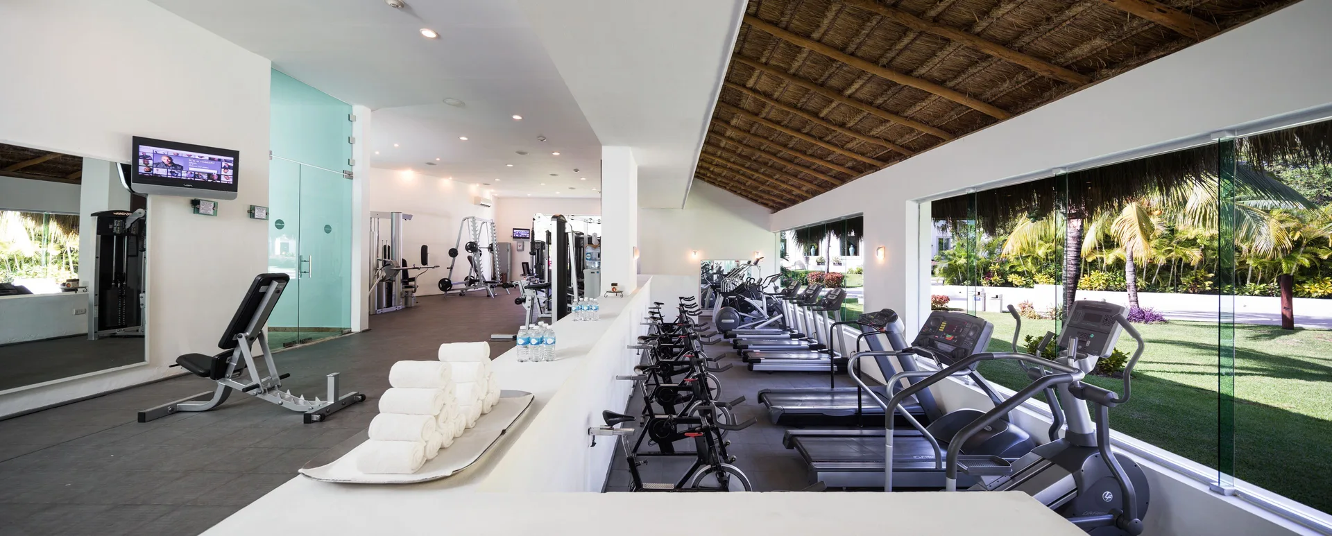 Fitness center with treadmills and weight equipment at BlueBay Grand Esmeralda.