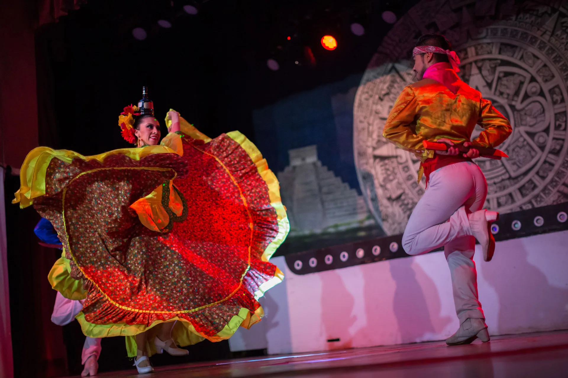 Colorful folkloric dance performance on stage at BlueBay Grand Esmeralda.