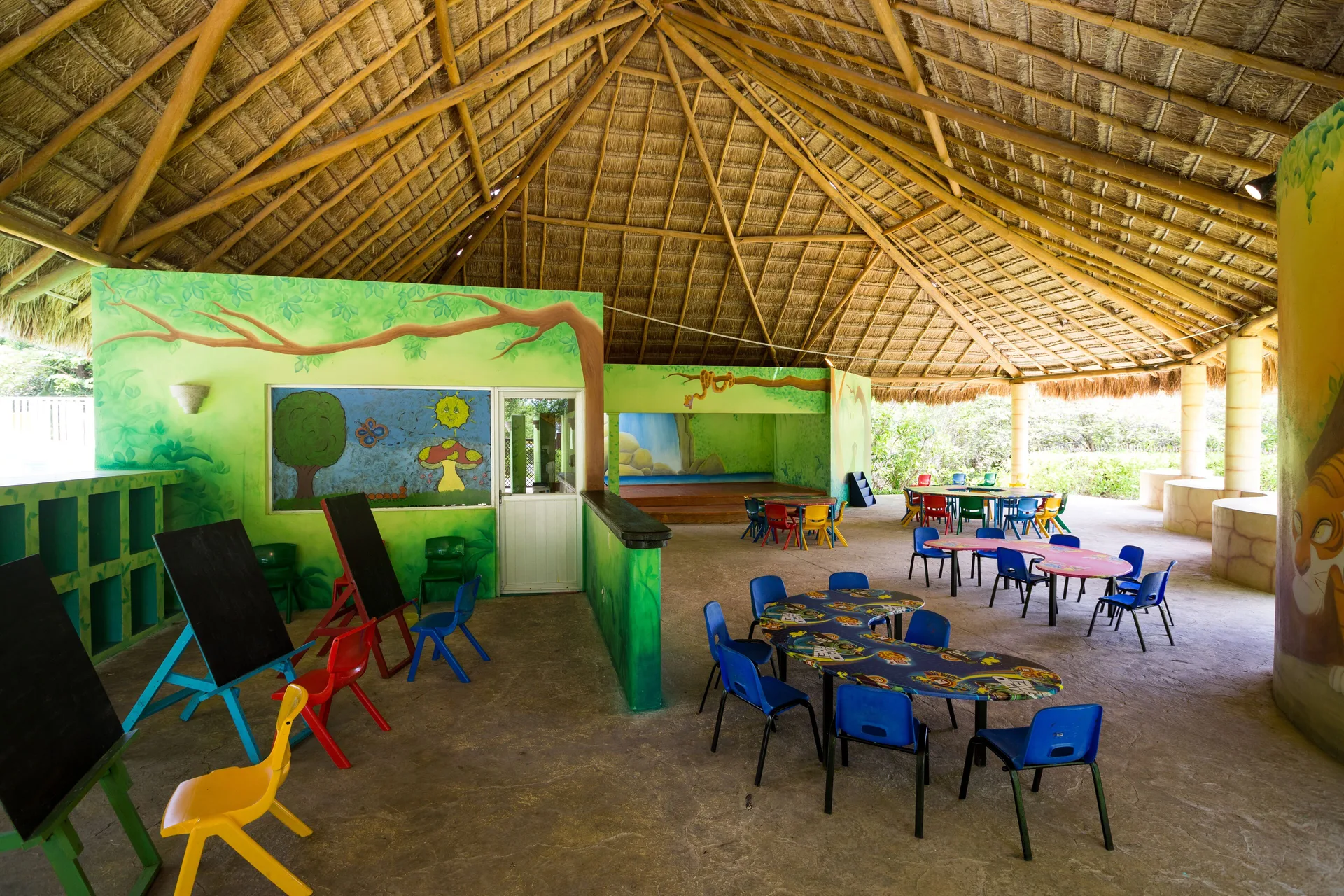 Kids club play area with small tables and chalkboards at BlueBay Grand Esmeralda.