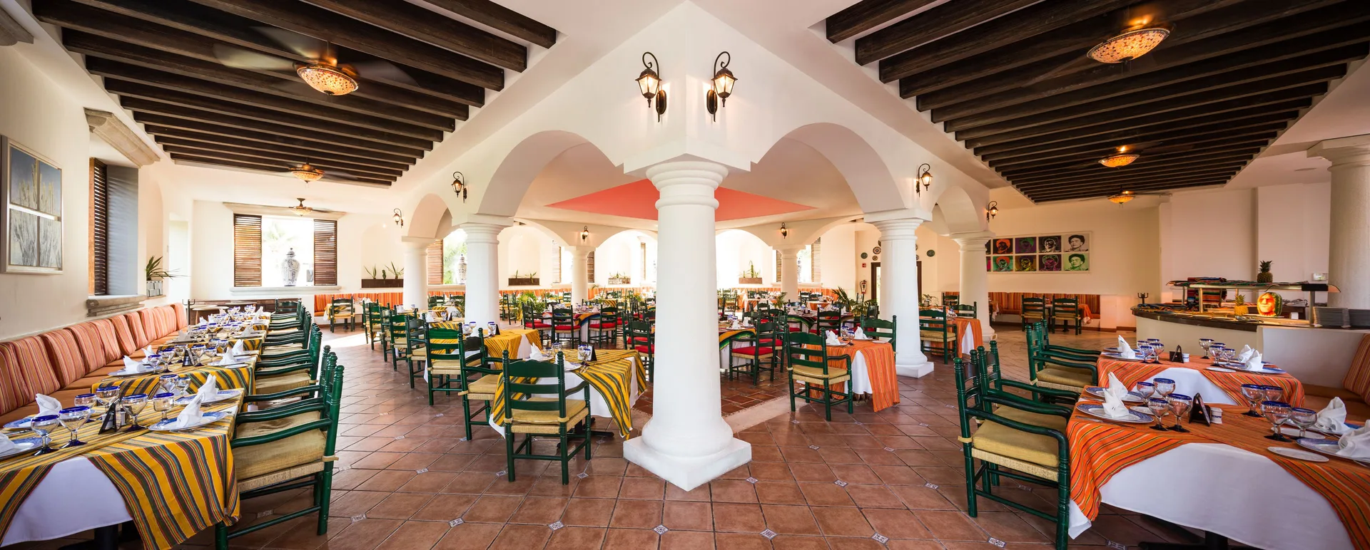 Mexican-style dining room with striped table linens at BlueBay Grand Esmeralda.