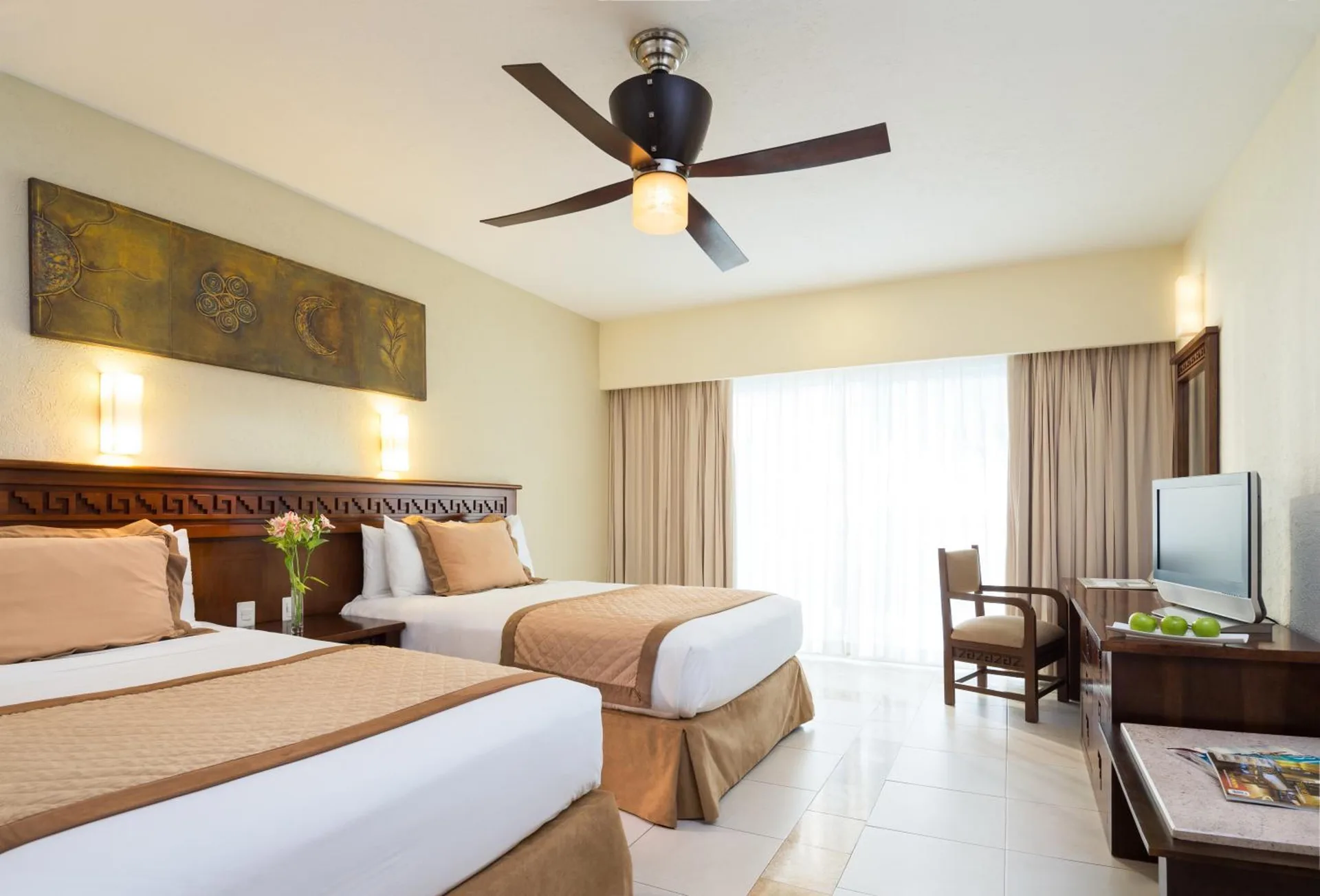 Deluxe Garden View room with two beds and seating area at BlueBay Grand Esmeralda.