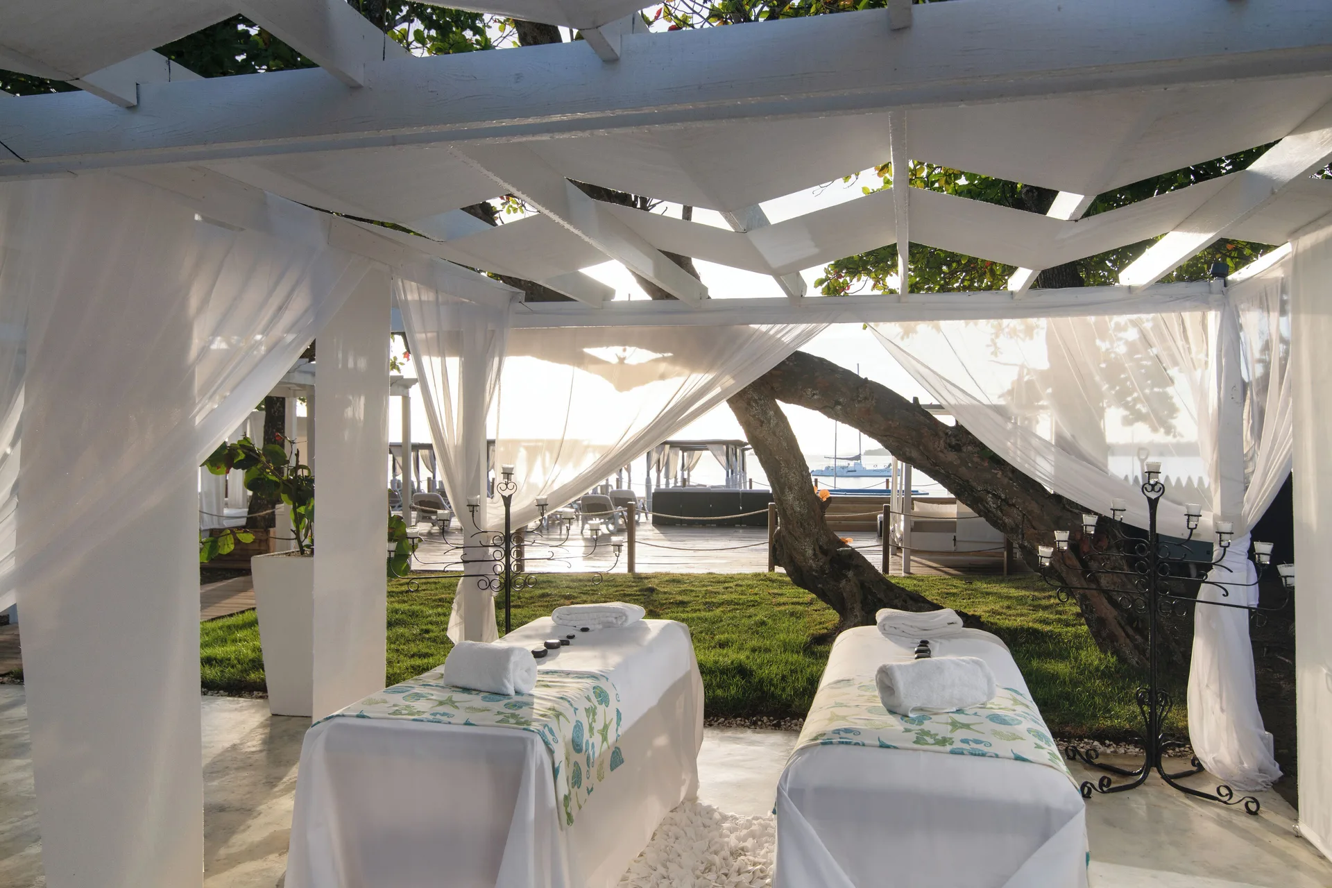 Outdoor massage tables under white drapes at BlueBay Villas Doradas.