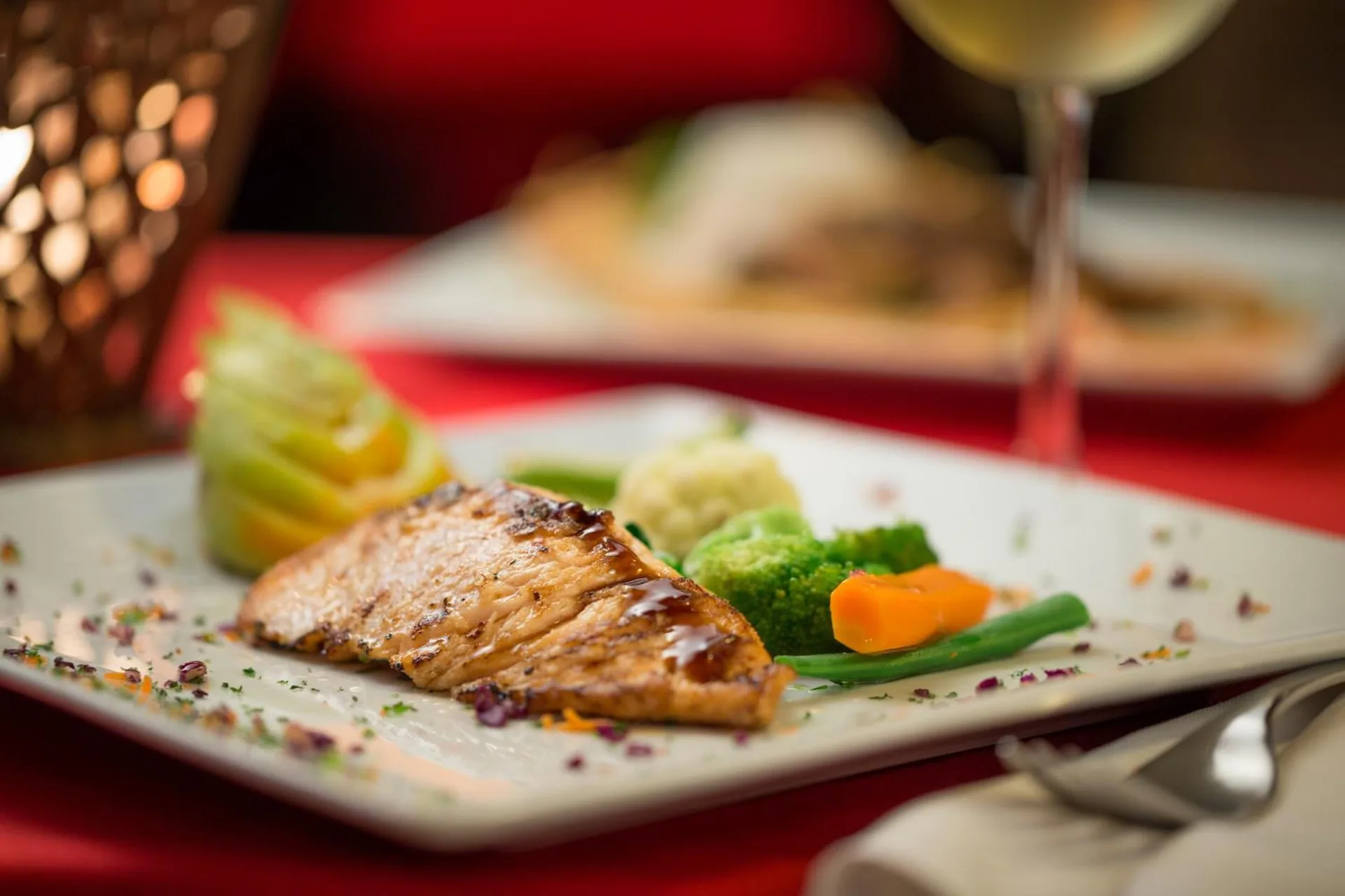 Grilled fish with vegetables on a plated entrée at BlueBay Villas Doradas.