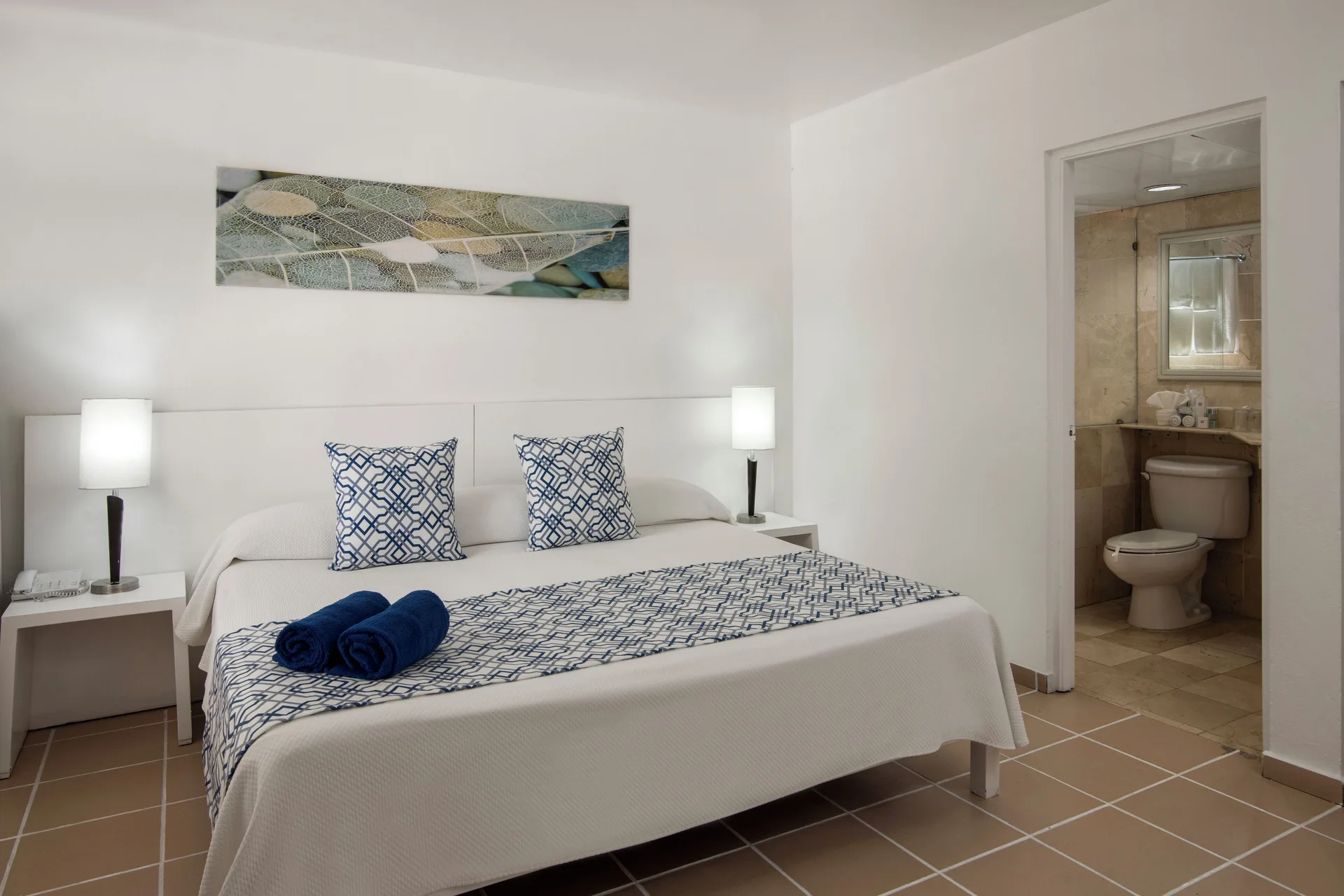 Superior Room king bed and bathroom at BlueBay Villas Doradas.