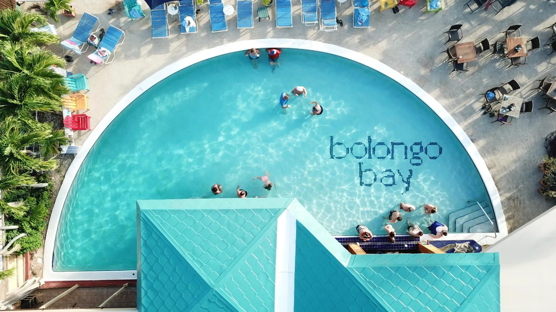 Aerial view of the pool with loungers and swimmers at Bolongo Bay Beach Resort.