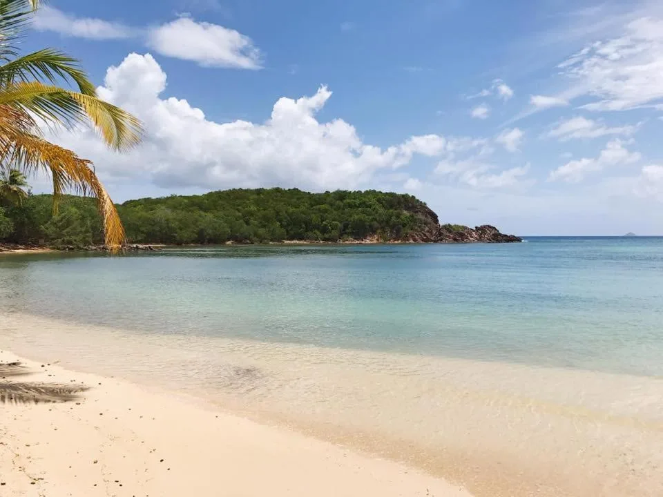 Calm sandy beach and blue bay at Bolongo Bay Beach Resort.