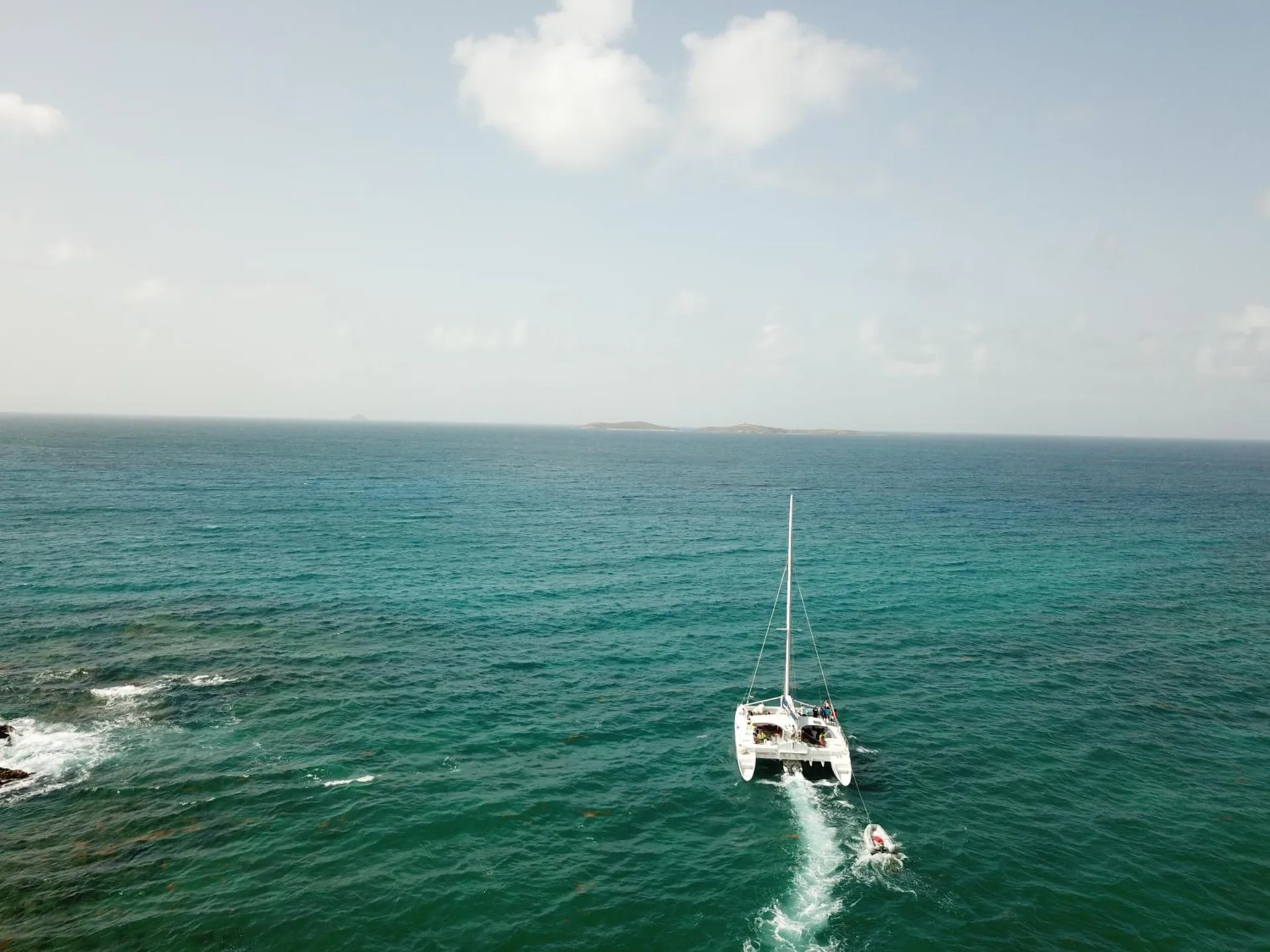 A catamaran sails across open turquoise water near Bolongo Bay Beach Resort.