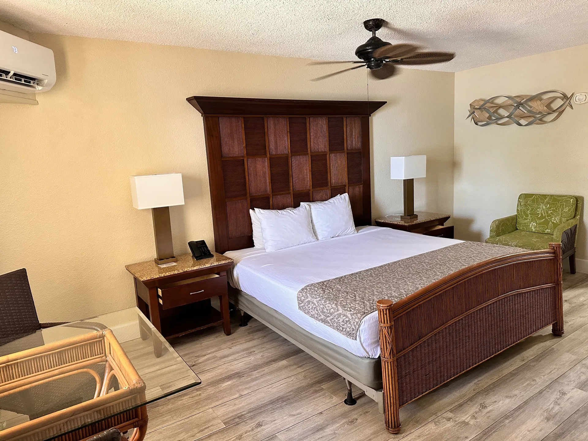King bed guest room with wicker furniture at Bolongo Bay Beach Resort.