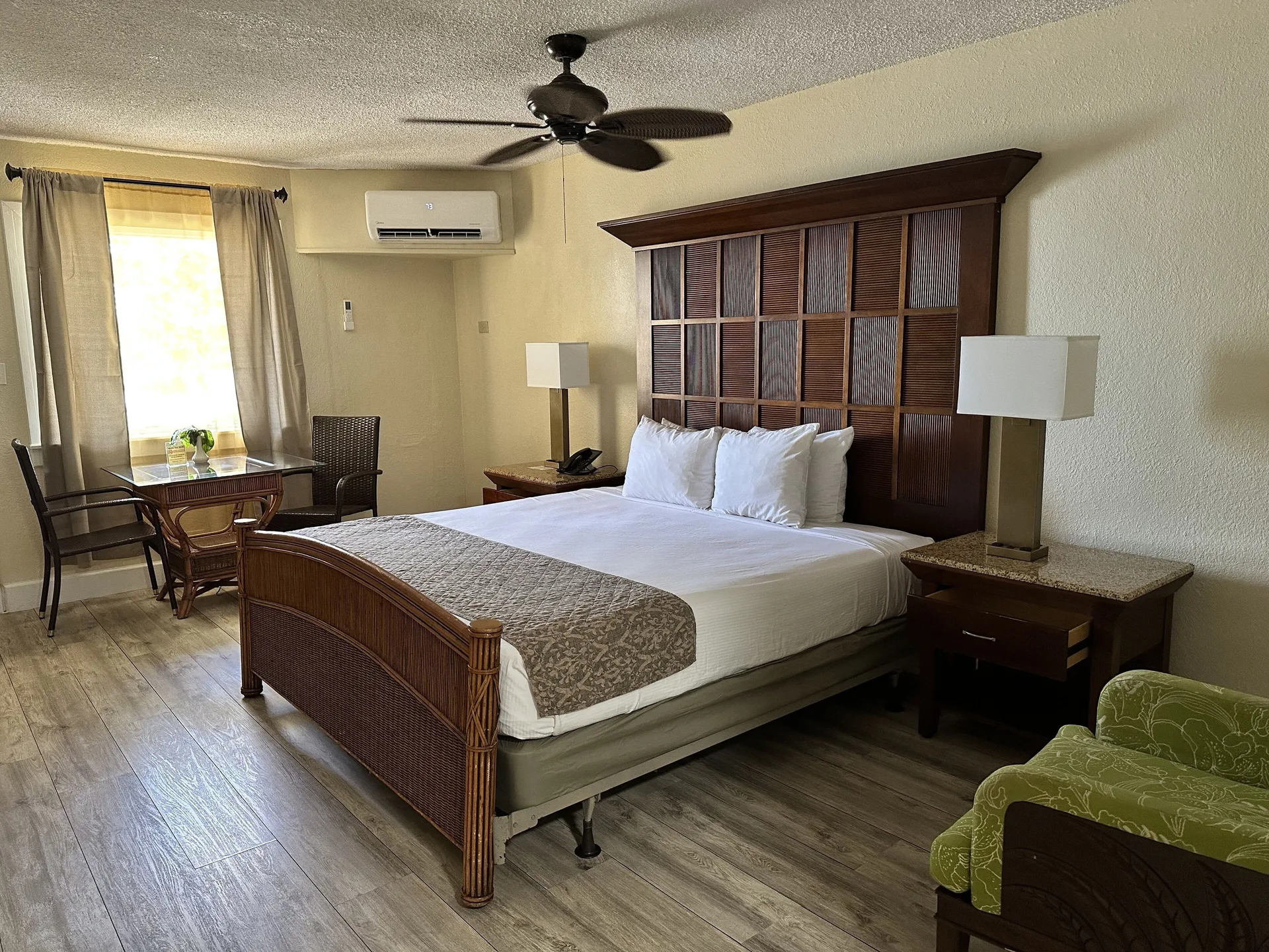 King bed room with window table and green chair at Bolongo Bay Beach Resort.