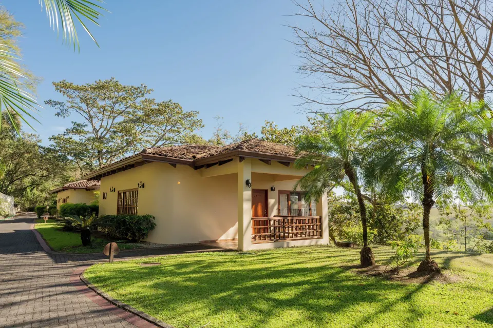 Junior Suite exterior with terrace and landscaped lawn at Borinquen Thermal Resort.