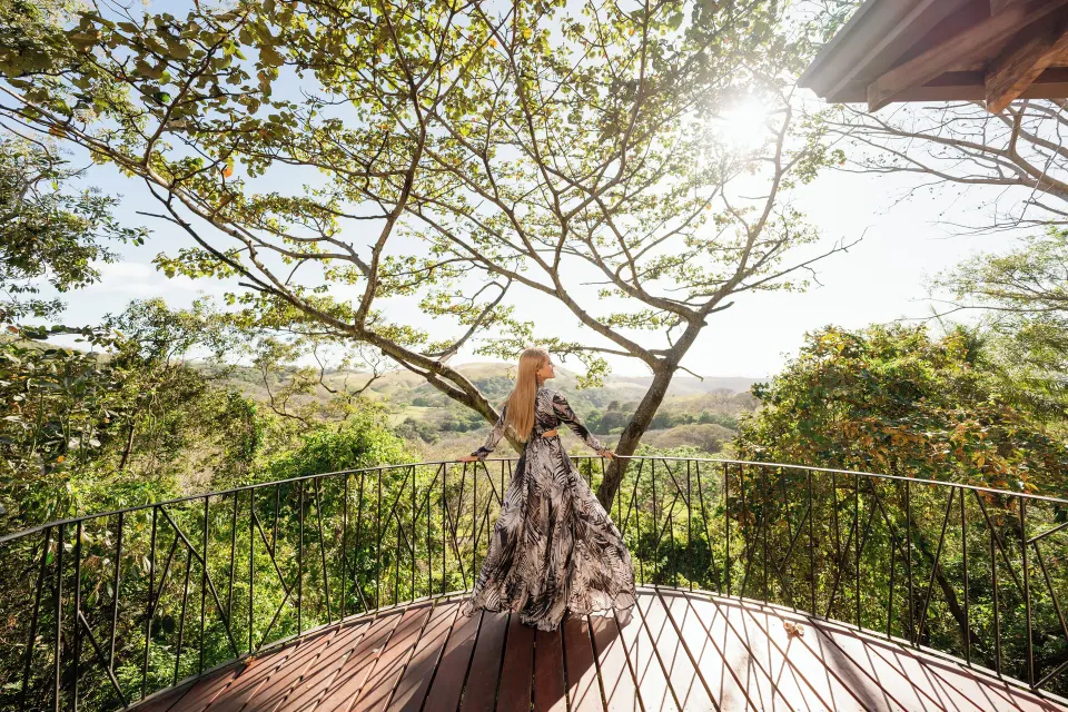 Junior Suite terrace overlook with trees and hills at Borinquen Thermal Resort.