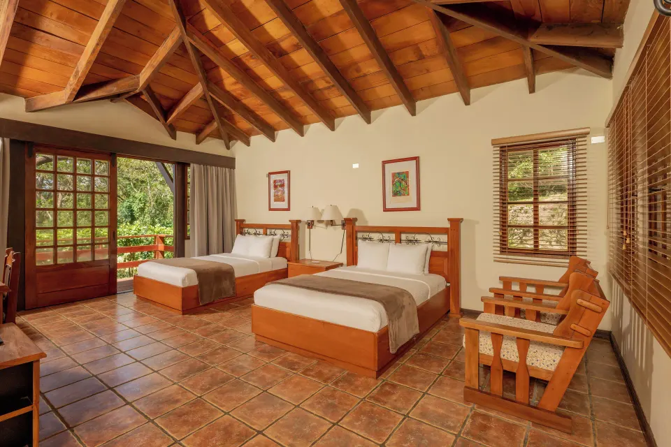 Villa Terrace Garden View room with two beds and wood ceiling at Borinquen Thermal Resort.