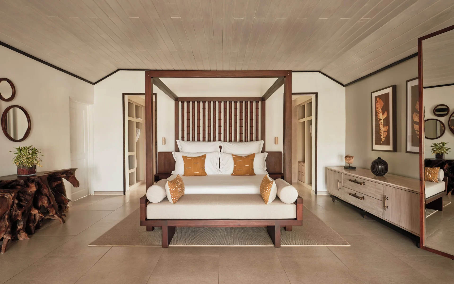 Garden Suite bedroom with four-poster bed, daybed and dressers at Carlisle Bay.