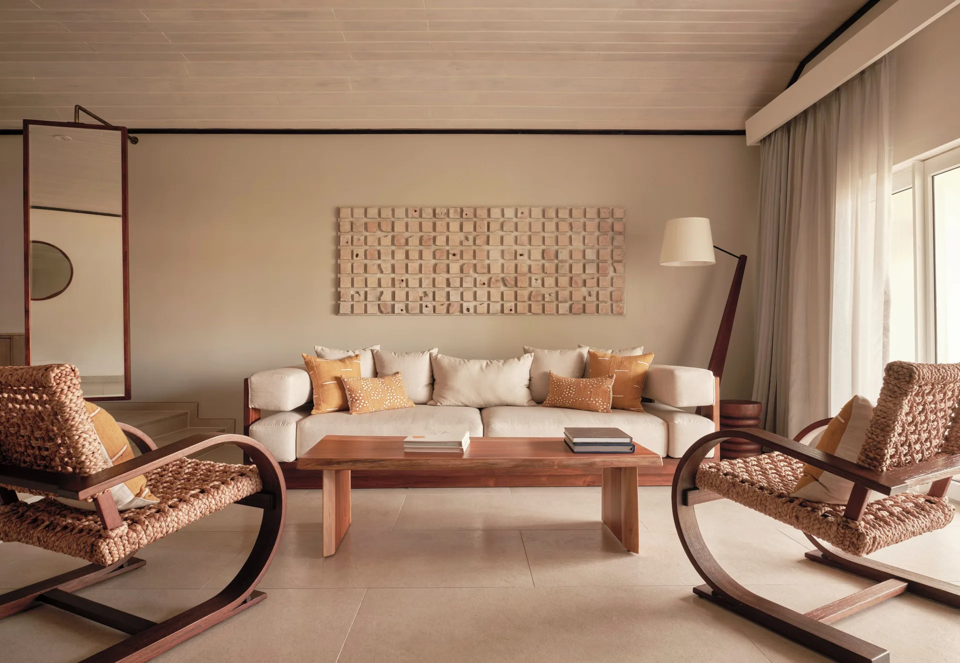 Garden Suite living area with sofa, rocking chairs and coffee table at Carlisle Bay.