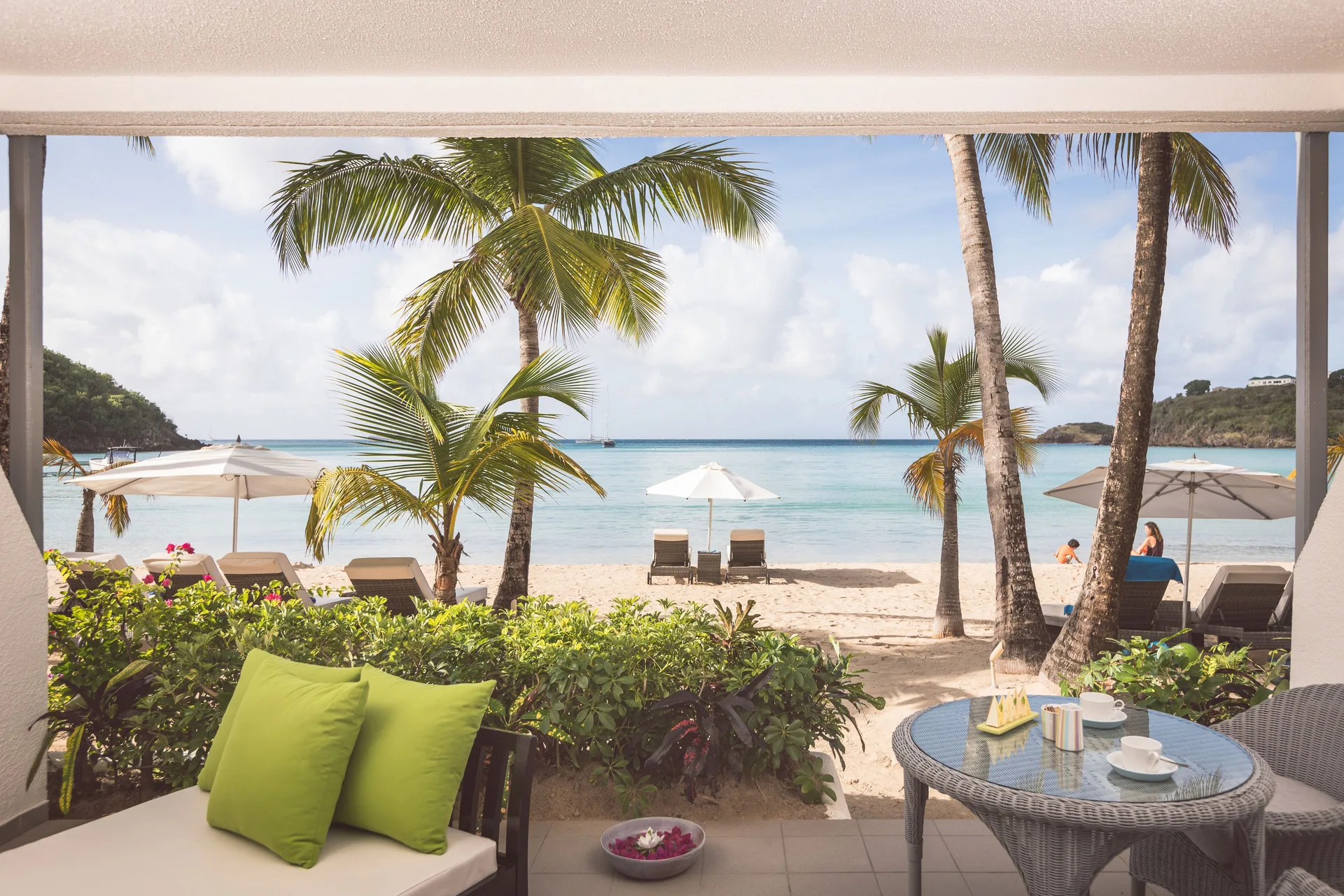 Terrace beach suite patio at Carlisle Bay with seating facing the sand and sea.