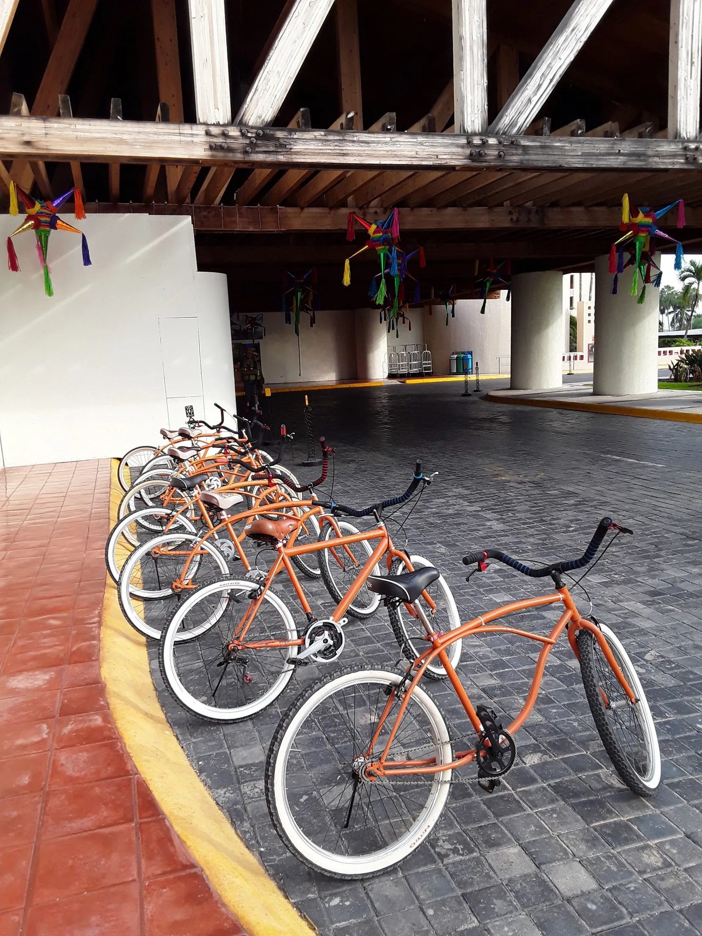 Orange bicycles lined up beneath the covered entry at Club Regina Puerto Vallarta.