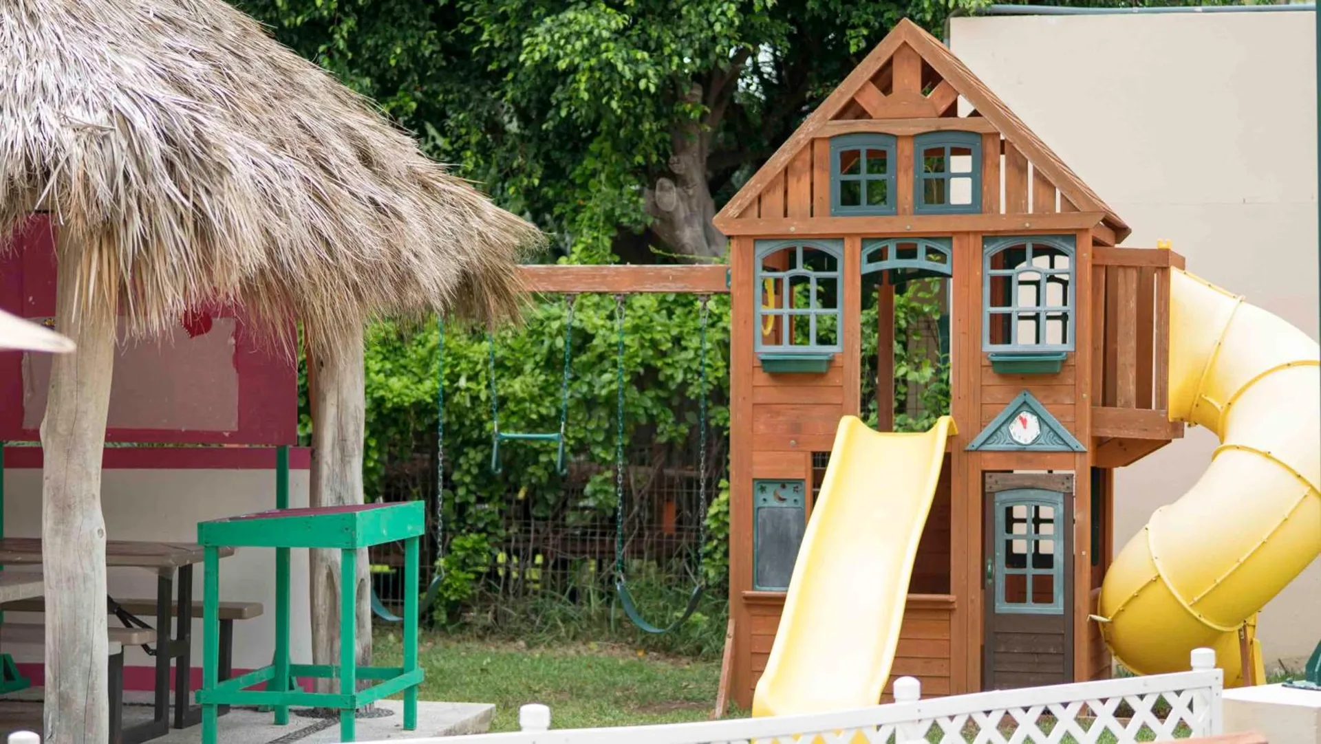 Children’s play area with slides and palapa seating at Club Regina Puerto Vallarta.