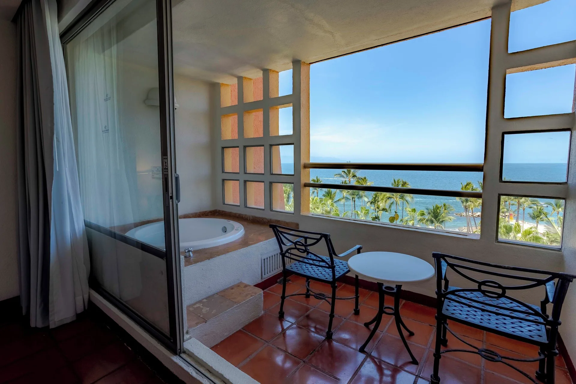 Ocean view suite balcony with tub and seating at Club Regina Puerto Vallarta.