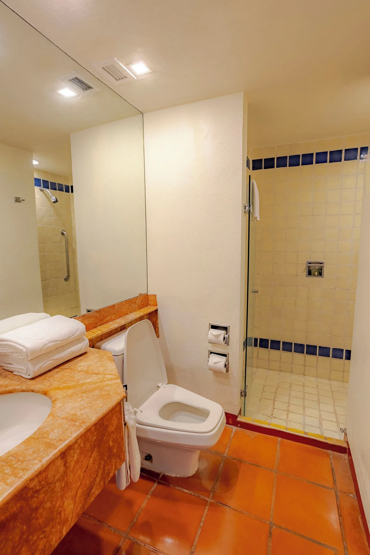 Suite bathroom with vanity and glass shower at Club Regina Puerto Vallarta.