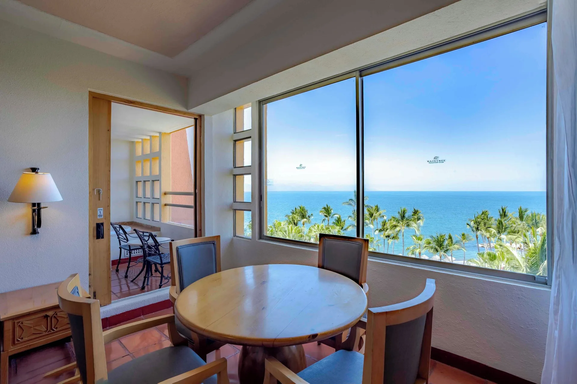 Ocean view dining nook and balcony in a suite at Club Regina Puerto Vallarta.