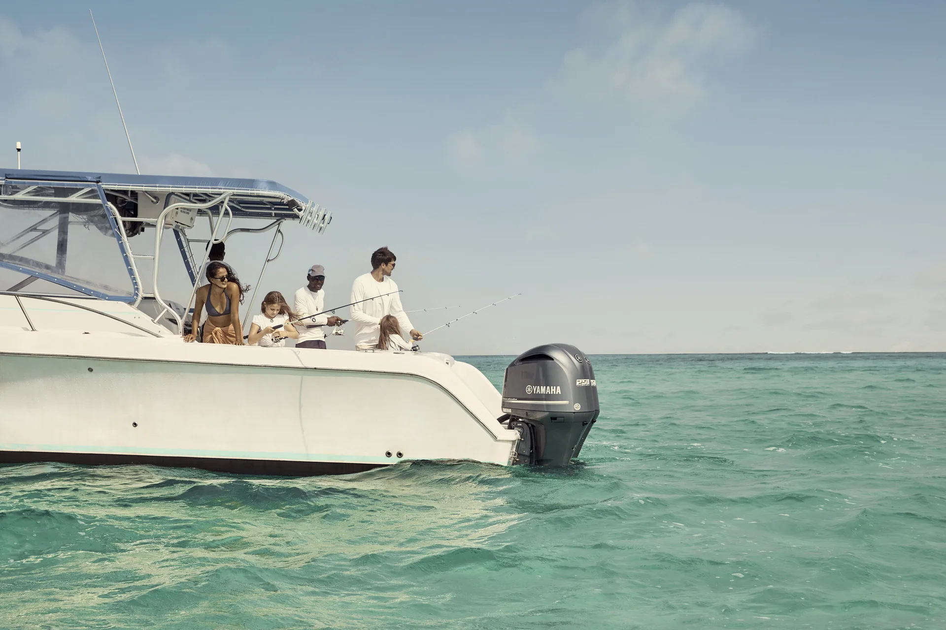 Guests fish from a boat on clear turquoise water near COMO Parrot Cay.